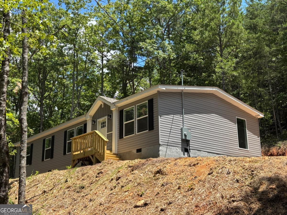 Brand new manufactured home on permanent foundation. Brand new private well, new septic tank. Landscaped yard with sod. Brand new asphalt driveway. You cannot beat the privacy from this home. Such quiet and peaceful property. 3 bedrooms, 2 full bathrooms, 2 separate living room areas, built in shelving. Master bath with tiled shower. Home comes with 1 year warranty. Agent is owner.