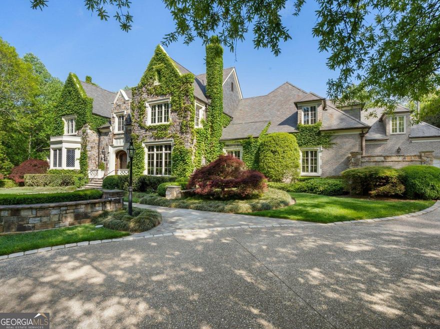 Set on an expansive three-acre private estate in Atlanta's exclusive Paces Ferry neighborhood in Buckhead, this stunning custom stone English manor, designed by renowned architect William T. Baker and built by custom builder McGarity.Timeless elegance combined with modern sophistication. Exceptional value at this price and available now. This gated property set way back from the street with a sweeping drive leading to a meticulously designed motor court and four-car garage, ensuring plenty of parking options. The interiors finishes are a testament to exceptional craftsmanship, beginning with the grand two-story foyer, where oak paneling and marble floors set a luxurious tone. To the left, an elegant study with fireplace provides a refined retreat. To the right, is a formal living room with fireplace or seating area. The heart of the home is the chefs kitchen and separate catering prep kitchen. Featuring two expansive islands clad in marble, professional-grade appliances, and dual pantries - including a butlers pantry - designed to make entertaining seamless. This space flows effortlessly into the spacious family room, complete with soaring vaulted ceilings, a cozy fireplace, and an adjacent sunroom that invites natural light and views of the lush surroundings. A standout feature is the glass conservatory, imported from England, offering a serene space to enjoy the gardens year-round. The main-level primary suite is a private sanctuary, complete with a sitting area, fireplace and overlooking the pool.  Two separate generously sized dressing rooms. Upstairs, four additional bedrooms, each with en suite bathrooms, provide ample accommodations for family and guests. A versatile bonus room and an elevator that accesses all three levels add to the homes functionality. Whole house generator, upgraded integrated lighting and security system. The terrace level is designed for recreation and relaxation, boasting a billiards area, full bar, wine cellar, fitness center, sauna, and a state-of-the-art movie theater. Outside, the grounds, envisioned by famed landscape architect John Howard, offer a resort-like experience. Enjoy lush, professionally curated gardens with over 70 specimen Japanese Maples, a sparkling pool with a hot tub, an open-air summer pavilion, and a dedicated play area with playhouse.  This 3 acre estate offers unparalleled access to Buckhead premier shopping, dining, and some of the cities top public and private schools. Own  a legacy property blending classic sophistication with modern amenities in one of Atlanta's most sought-after locations.