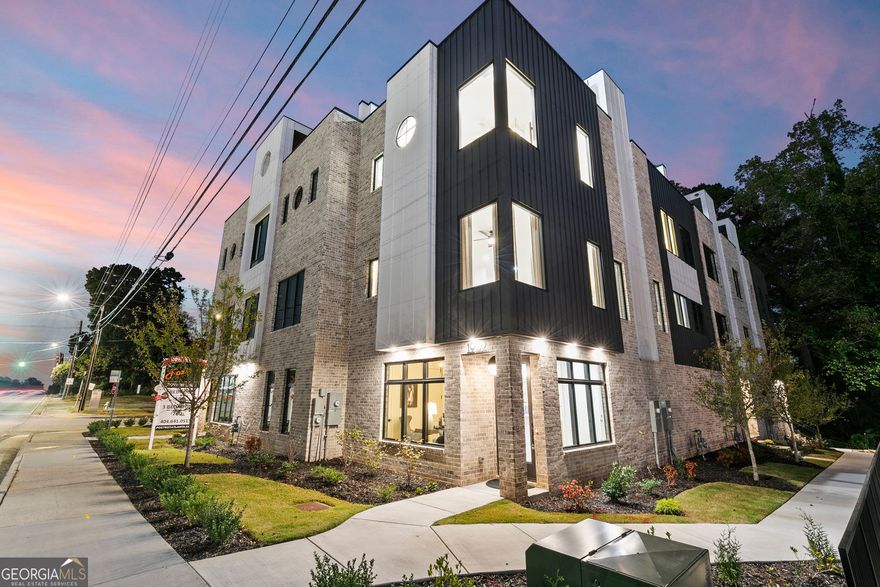 Turn off 8th Street and glide through the motor court into your private two-car garage, the beginning of something special. Inside, the first floor welcomes you with a bright, modern foyer, a full bath, and a spacious bedroom that doubles beautifully as a home office, complete with two closets for effortless organization. Ascend to the open concept main level where luxury meets design. The kitchen is a showstopper featuring one-of-a-kind marble countertops, two-tone cabinetry, a generous island for entertaining, walk-in pantry, and a sleek dry bar with a built-in wine fridge. Fulgor stainless steel appliances anchor the space, complemented by designer lighting and hardwood floors that flow seamlessly throughout. The dining area sets the stage for your first dinner party, while the elevated living room framed by corner windows offers striking views of the PDK runways below. A discreet half bath adds an extra layer of convenience for guests, and a large walk-in storage closet near the staircase ensures everything you need has a stylish place to stay tucked away. On the third level, the indulgence continues with an ensuite secondary bedroom, hallway laundry, and an elegant primary suite boasting dual walk-in closets with custom shelving and a spa-like bath featuring a double vanity, water closet, and oversized walk-in shower. And just when you think you've seen it all, the rooftop terrace steals the show. Stretching the full length of the home, it is finished in lush turf with panoramic views of Stone Mountain and the runway lights of Peachtree-DeKalb Airport. Perfect for sunset cocktails or midnight conversations, a gas line awaits your custom outdoor kitchen upgrade. Beyond the home, The Foxtrot offers an enviable lifestyle designed for those who move to their own rhythm. Surrounded by six parks and the sprawling 33-acre Ashford Park Reserve, outdoor adventures are steps away. Minutes from Emory University, top hospitals, major highways, and an array of dining and entertainment options, you'll enjoy the best of urban living with the ease of a connected community. Experience luxury living at its finest at The Foxtrot, where prime location, exceptional craftsmanship, and unparalleled design converge to create a lifestyle unlike any other. At The Globemaster, every landing feels like a grand arrival.
