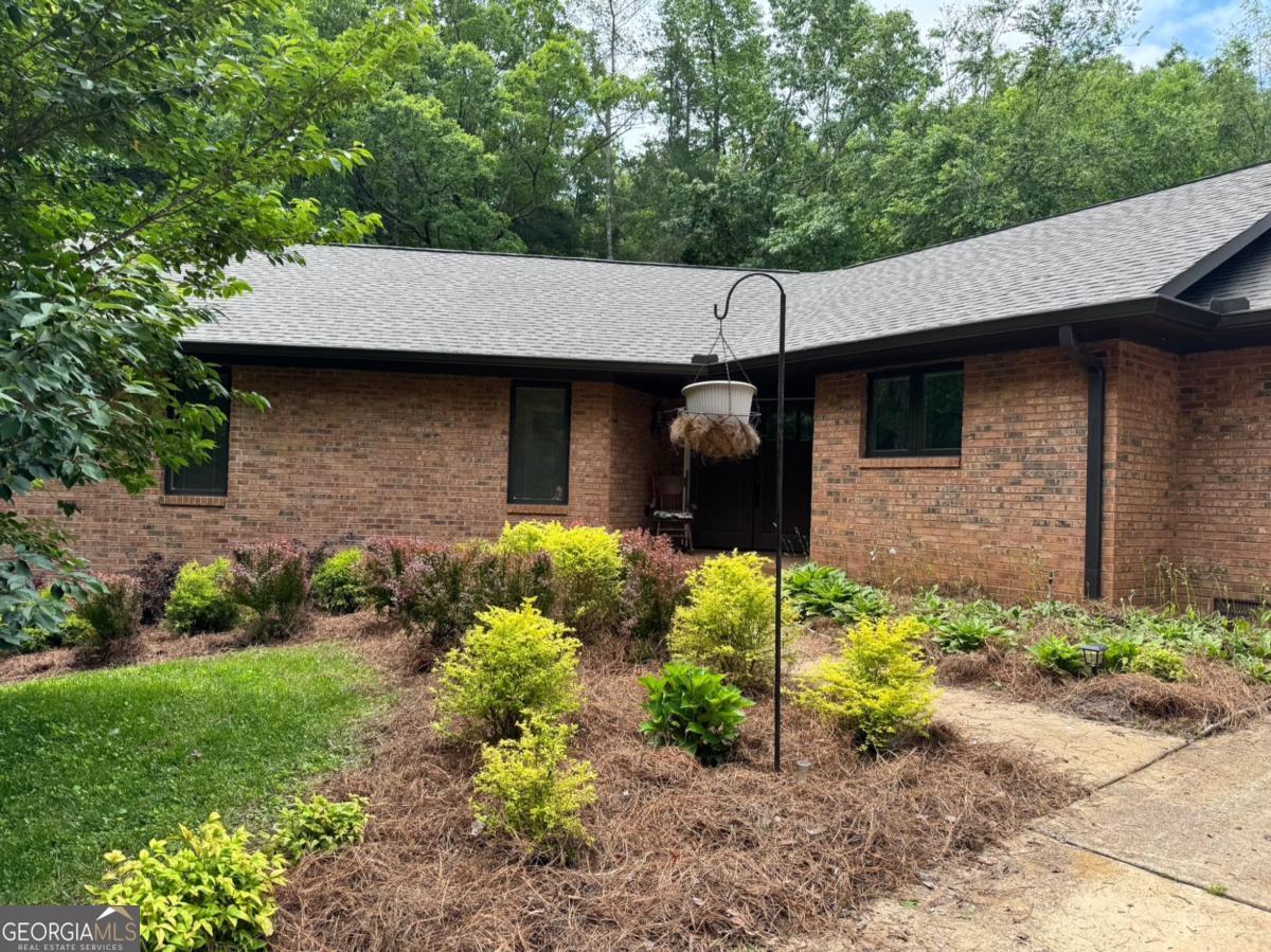 Beautiful 3 Bedroom 2 Bath Home on 5 Private acres in a very well established neighborhood with NO HOA, Covenants, or Restrictions * Amazing LOCATION! Just off of GA 400 & within 20 minutes of Dahlonega, Cumming, or Gainesville, and at the gateway to the North Georgia Mountains * Medical Facilities, Shopping, Restaurants, & Schools within 5 miles * Inviting Front Patio with sitting area & Double Doors Entering the main area* Bright & Open Floor plan * Custom Beams & Louvered Skylights pour sunshine into the main living room area (remote operated) * Cozy Stacked Stone Fireplace with Gas Logs * Double Pane windows with Solar Shades * Peace & Serinity in the attached Sunroom overlooking a spacious private back yard * Kitchen features new KitchenAid appliances (2 yrs old) with Double Oven * Solid Surface Counter Tops * Breakfast Bar * Custom Built Cabinets * Double Under Mounted Sink * Large Walk In Pantry * Laundry Room located on Main with Half Bath * 20x20 Garage with plenty of extra parking area in driveway * RV parking space with RV Hook Up by Garage * Main Floor has 2 Nice Size Bedrooms * Shared Full Bath with Tub/Shower combo * Master on Main with Dual Closets * Ensuite bath, Large shower w/ Rain Heads & Double Vanity with Lighted Mirror * Open Basement Finished with area for Kitchenette, Closet Storage, & 3rd Full Bathroom *Separate Entry to Basement w/ Patio area makes easy ADA unit or rental income * Additional Separate Octagon Outbuilding available to finish as ADU, home office, gym, studio, or storage(has power and stubbed for water) * Approx 2500 SF Living Space * Like NEW Home! Feel like you are living in the country, with all the amenities you need just right next door! Lake Lanier, The Appalachian Trail, Amicalola Falls and much more within a short drive * 1 Hour outside of the Atlanta * NO HOA on 5 wooded acres! Mature landscaping & ultimate privacy! Come take a look!