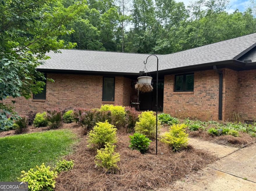 Beautiful 3 Bedroom 2 Bath Home on 5 Private acres in a very well established neighborhood with NO HOA, Covenants, or Restrictions * Amazing LOCATION! Just off of GA 400 & within 20 minutes of Dahlonega, Cumming, or Gainesville, and at the gateway to the North Georgia Mountains * Medical Facilities, Shopping, Restaurants, & Schools within 5 miles * Inviting Front Patio with sitting area & Double Doors Entering the main area* Bright & Open Floor plan * Custom Beams & Louvered Skylights pour sunshine into the main living room area (remote operated) * Cozy Stacked Stone Fireplace with Gas Logs * Double Pane windows with Solar Shades * Peace & Serinity in the attached Sunroom overlooking a spacious private back yard * Kitchen features new KitchenAid appliances (2 yrs old) with Double Oven * Solid Surface Counter Tops * Breakfast Bar * Custom Built Cabinets * Double Under Mounted Sink * Large Walk In Pantry * Laundry Room located on Main with Half Bath * 20x20 Garage with plenty of extra parking area in driveway * RV parking space with RV Hook Up by Garage * Main Floor has 2 Nice Size Bedrooms * Shared Full Bath with Tub/Shower combo * Master on Main with Dual Closets * Ensuite bath, Large shower w/ Rain Heads & Double Vanity with Lighted Mirror * Open Basement Finished with area for Kitchenette, Closet Storage,  & 3rd Full Bathroom *Separate Entry to Basement w/ Patio area makes easy ADA unit or rental income * Additional Separate Octagon Outbuilding available to finish as ADU, home office, gym, studio, or storage(has power and stubbed for water) * Approx 2500 SF Living Space * Like NEW Home!  Feel like you are living in the country, with all the amenities you need just right next door! Lake Lanier, The Appalachian Trail, Amicalola Falls and much more within a short drive * 1 Hour outside of the Atlanta * NO HOA on 5 wooded acres! Mature landscaping & ultimate privacy! Come take a look!