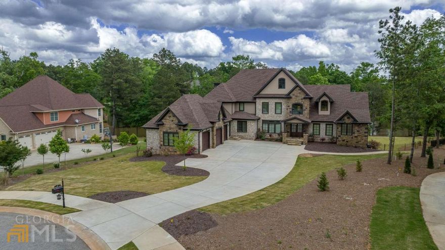 Picture yourself rushing home every evening to your own private oasis in North Oconee! Enter the oversized double front doors of this custom-built masterpiece to a grand entry foyer. Enjoy both entertaining and everyday living in the chef's kitchen, complete with premium custom cabinets, Thermador Appliances, expansive island with prep sink and wine rack, 6 burner gas cooktop with decorative vent hood and pot filler and an oversized walk-in pantry with wood shelving and granite countertops. The kitchen easily flows into the Great Room creating the perfect open living space. The mudroom and laundry room are combined to make organization a breeze and is conveniently located right off the 3-car garage. Rounding out the living area on the main level is a formal dining room and private office with barn doors. The owner's suite is truly a retreat, tucked away in a private corner of the main level. The bedroom itself is oversized with its own covered porch and two separate walk-in closets. The owners bath features a vessel tub and spa shower with frameless glass enclosure. The main level also includes a guest bedroom with a private bath and an additional conveniently located half bath. Walk up the floating staircase to find 4 spacious secondary bedrooms, each with a private bath with tiled, frameless shower and walk-in closet. A second staircase leads to the terrace level complete with a king-sized bar and plenty of living space for a seating area and separate gaming area. In addition, this level features a private gym, a half bath, plenty of storage space and second mudroom and full bathroom convenient to the pool and outdoor retreat. As you exit the terrace level, no detail was overlooked in completing this backyard paradise. Including ample space for entertaining, a freeform pool, jacuzzi, stacked stone waterfall and fire pit. A spiral staircase leads you to a second covered porch right off the kitchen. This distinctive home is less than 2 years old, everything you could want and so much more!