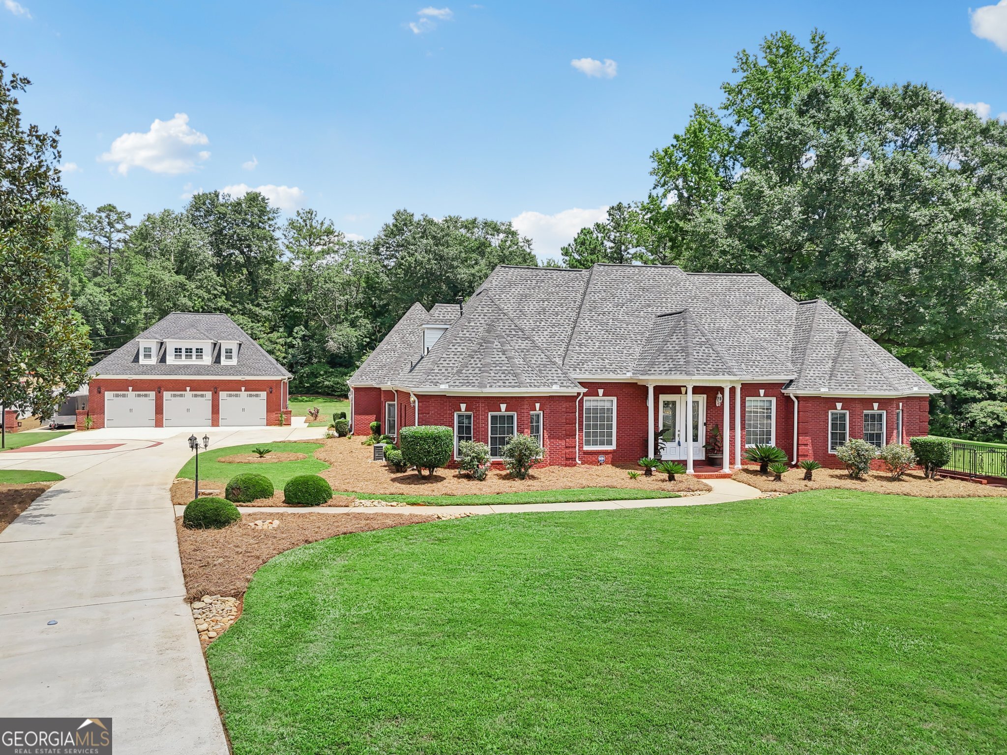 Secluded Luxury on Nearly 3 Acres - A Grand Stone Mountain Estate Beyond the gated tree lined entry and private drive awaits this exquisite 7,846 sq ft custom residence-an exceptional blend of elegance, privacy, and modern functionality. Perfectly positioned on 2.79 lush acres with no HOA, this executive estate offers the rare freedom to live expansively. The main residence is designed to impress, featuring soaring ceilings, generous natural light, and refined finishes throughout. A chef's kitchen anchors the home, opening seamlessly to multiple living and entertaining spaces. The fully finished terrace level offers a fresh, flexible layout ideal for a home theater, fitness suite and multigenerational living. Outdoors, expansive ground level and suite level decks overlook manicured park-like grounds that invite both grand entertaining and tranquil retreats. Car collectors and creatives will love the five-car garage capacity-including a detached, climate-controlled three-car garage with a fully outfitted guest studio, perfect for in-law living or high-yield rental potential. Whether you're seeking a private compound, a multigenerational sanctuary, or a sophisticated home with income opportunity, this gated estate is a rare offering where luxury and lifestyle meet.