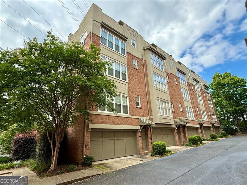 Welcome to 1376 Parkview Lane NE - a thoughtfully designed 3-bedroom, 2.5-bathroom, end unit townhome offering the perfect balance of comfort, convenience, and city living without the noise. Nestled on a quiet street on the edge of Piedmont Park, this home provides a peaceful retreat while keeping you close to everything Atlanta has to offer. Inside, you'll find a light-filled open floor plan with hardwood floors on the main level, an open concept kitchen with stone countertops and stainless steel appliances, a gas fireplace, newer energy efficient windows, and flexible living spaces that make everyday living and entertaining a breeze. One of the standout features of this home is the expansive rooftop deck - a private outdoor escape with stunning skyline views. It's the perfect spot to relax, entertain guests, or enjoy the seasonal glow of the Atlanta Botanical Garden Holiday Lights under the stars right from home. Additional features include a spacious primary suite with a walk-in closet, two guest bedrooms and a two-car garage. And for those who love the outdoors, multiple access points to the Atlanta BeltLine and Piedmont Park are at the end of the two streets that border the community - ideal for the outdoor enthusiasts and connecting with nature and nearby neighborhoods. Conveniently located to shopping, dining, parks, and major highways, this townhome offers easy access to Midtown and Buckhead without the constant noise and bustle of being in the center of it all. Come experience a quieter side of city living - without missing out on the perks. Up to $32,500 in Down Payment assistance available to qualified Homebuyers through Preferred Lender!