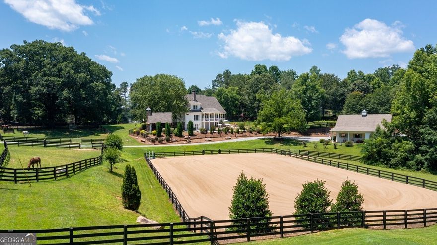 Quintessential hobby farm perfectly situated on 3.6 acres located in sought after East Cherokee County! Enjoy the lush grounds this property offers from the outdoor riding arena with irrigation, five stall center aisle way barn with tack room, outdoor pool pavilion with cedar shake roof/stack stone fireplace overlooking 20x40 saltwater pebble tec pool and additional barn for tractors & mowers. Gorgeous open floor plan concept with owners suite on main, two story great room overflowing with natural light, chefs kitchen with top of the line appliances, oversized island, quartz countertops and custom cabinetry. Secondary level offers 4 bedrooms with 2 bathrooms. Full finished terrace level with additional bedroom and bathroom, billiard room ideal for entertaining and ample storage space!