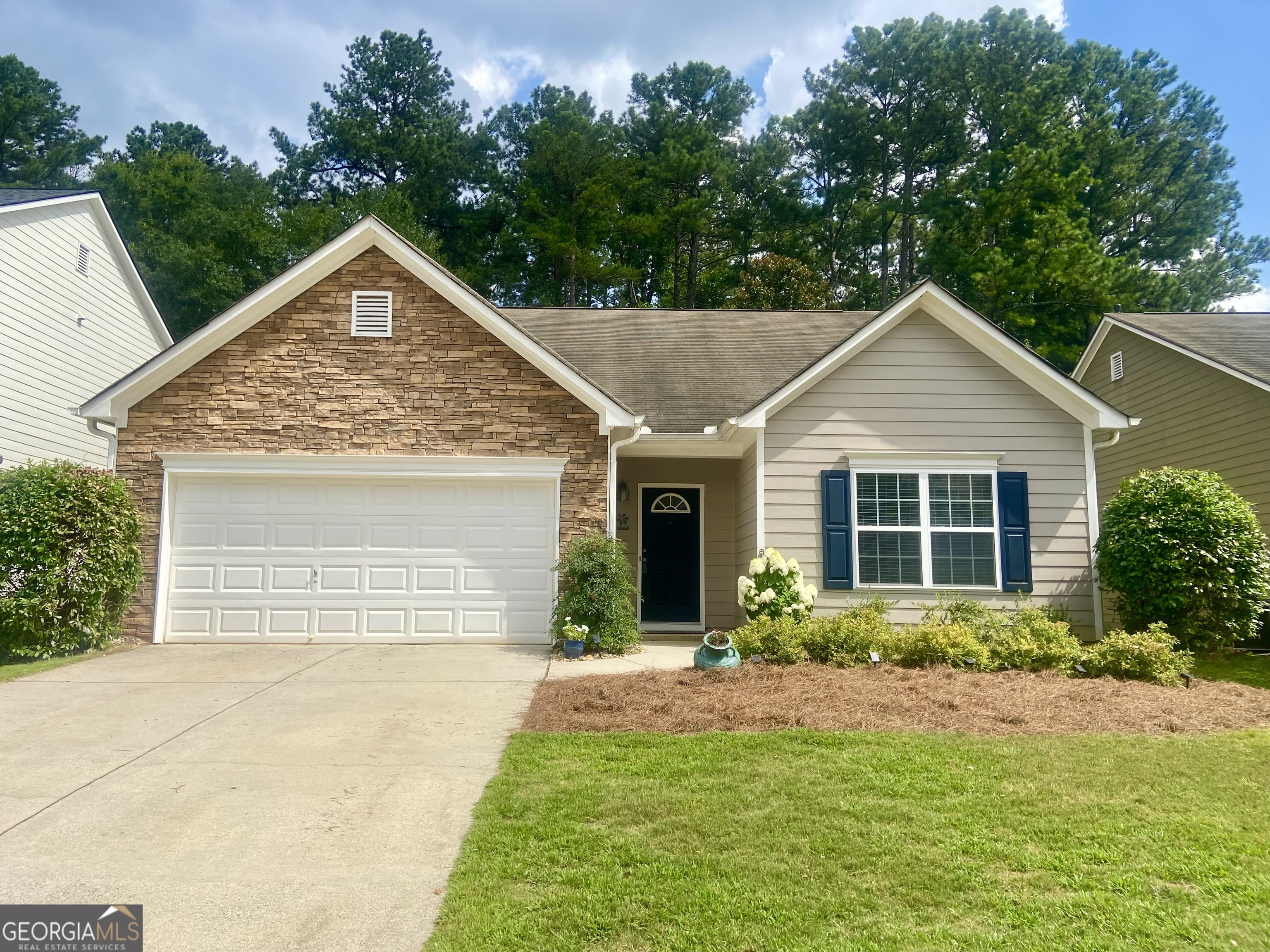 MOVE-IN READY RANCH IN PRIME LOCATION! Welcome to this beautifully updated and meticulously maintained step-less ranch home in the highly sought-after Whitfield at Ridgewalk subdivision. Just a short distance from vibrant Downtown Woodstock, this charming residence offers the perfect blend of comfort, convenience, and community. This 3-bedroom, 2-bathroom home boasts an inviting open floor plan with soaring 10-foot smooth ceilings and an abundance of natural light. The entire interior has been freshly repainted, luxury vinyl plank (LVP) flooring has been installed throughout living areas and brand new carpet installed in the bedrooms. The kitchen features crisp white cabinetry, brand-new stainless steel appliances, and a breakfast bar that opens seamlessly into the living room-perfect for entertaining. Just off the kitchen is a cozy eat-in dining area with sliding glass doors leading to a screened-in patio, ideal for enjoying summer evenings in peace. Step outside to a private backyard that backs up to a serene wooded area-no neighbors behind you! The front yard features attractive, low-maintenance landscaping that adds to this home's curb appeal. The neighborhood offers low HOA fees, a fantastic swimming pool with a kiddie pool and regular neighborhood social events that foster a true sense of community. Idyllically located near the Outlet Shoppes at Atlanta, numerous dining options, and major roadways (I-575/I-75), this home is also zoned for highly rated schools and benefits from low Cherokee County taxes. Whether you're a first-time buyer, downsizing, or just looking for a home with convenience and character-this one checks all the boxes. Schedule your showing today!