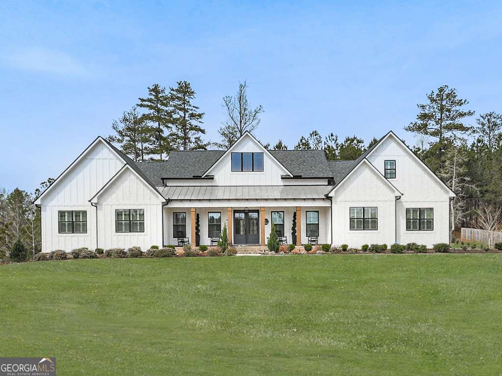 WELCOME HOME! Welcome to this exquisite 2023 custom-built home in the highly sought-after gated community Tate Reserve subdivision of Ball Ground, GA! Nestled on a sprawling 1.67-acre corner lot, this 5-bedroom, 4.5-bathroom home is one of the largest and most desirable properties in the community, boasting 4,166 sq. ft. of thoughtfully designed living space. Designed to complement the beautiful modern farmhouse-style homes throughout the neighborhood, this residence offers both elegance and functionality. Some of the main level features include an Open-concept kitchen & living area perfect for entertaining, a Spacious master suite with a luxurious en-suite bath, Three additional secondary bedrooms with two full bathrooms, Guest half-bath for added convenience! There is Dedicated office space and a Versatile flex room ideal for an extra bedroom, playroom, or second office Upstairs you will find a Large private bedroom with its own full bathroom perfect for guests or a teen suite! Outdoors you will find an Expansive back deck spanning the width of the home with a Covered bar area overlooking a huge cleared backyard! This home sits on One of the largest & most usable lots in the neighborhood! In addition to all these amazing things this home has one of the few Three-car garages in the neighborhood perfect for parking and storage! This exceptional home offers the perfect blend of luxury, space, and privacy, all within the serene, gated community of Tate Reserve! In addition to the clubhouse space, you can also hike around the 25 acres of land designated for conservation and hiking trail trails! The trailhead is conveniently located a short distance from this home! Conveniently located near crystal Falls lake and golf club, shopping, dining, and major highways, this is a rare opportunity to own one of the most impressive homes in the neighborhood. Schedule your private tour today!