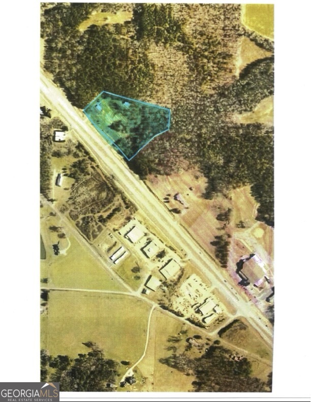 Commercial potential on 5.5 acres with 600 feet on Highway 27. 3000 sq ft office space, storage barn, 2 driveways, 2 electric meters, one water meter. Daily traffic count 12,000