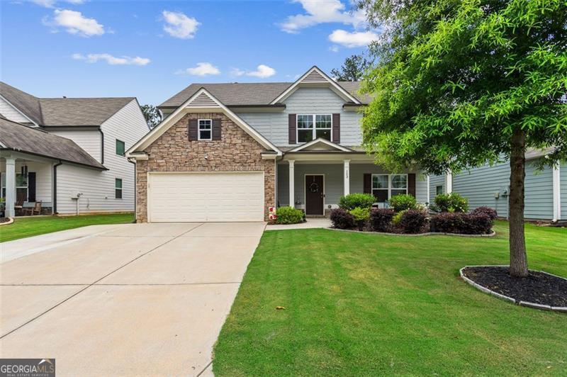 Welcome to 153 Woodland Court - a move-in ready 4-bedroom, 2.5-bath retreat in the highly sought-after Woodland Crossing community! Tucked away near a quiet cul-de-sac, this beautifully maintained home combines style, function, and comfort across 2,535 square feet. Step inside to a bright, open foyer with soaring ceilings, neutral tones, and luxury vinyl plank flooring on the main level, complemented by plush carpeting upstairs. Built in 2020, the home offers a flexible floorplan ideal for both daily living and entertaining. The heart of the home is the spacious kitchen featuring rich espresso cabinets, granite countertops, stainless steel appliances, a large island, and a walk-in pantry-perfect for culinary adventures. The adjacent dining area flows effortlessly into the oversized living space, which includes a mounted 86" TV that stays. Need extra space? A cozy flex room with a custom accent wall provides the perfect setting for a home office, lounge, or creative studio. Step outside and enjoy your screened-in patio with built-in indoor/outdoor speakers and a cozy outdoor fireplace. The private, fenced-in backyard features garden beds, a storage shed, and an extra parking pad-offering both charm and convenience. Upstairs, the spacious owner's suite boasts tray ceilings, a large walk-in closet, and a beautifully tiled walk-in shower with brand-new shower doors and dual vanities. Three additional bedrooms and a full laundry room complete the upper level. Extras include a newly installed alarm system, hanging shelf in the garage, and fencing that are all just 5 years old. Woodland Crossing offers unbeatable community perks-sidewalks, a sparkling pool & splash pad, lighted tennis court, a playground, and a picnic pavilion-all within minutes of shopping, dining, gyms, parks, and top-rated schools. ? Don't miss your chance to call this modern retreat home. Schedule your private tour today and discover all that 153 Woodland Court has to offer.