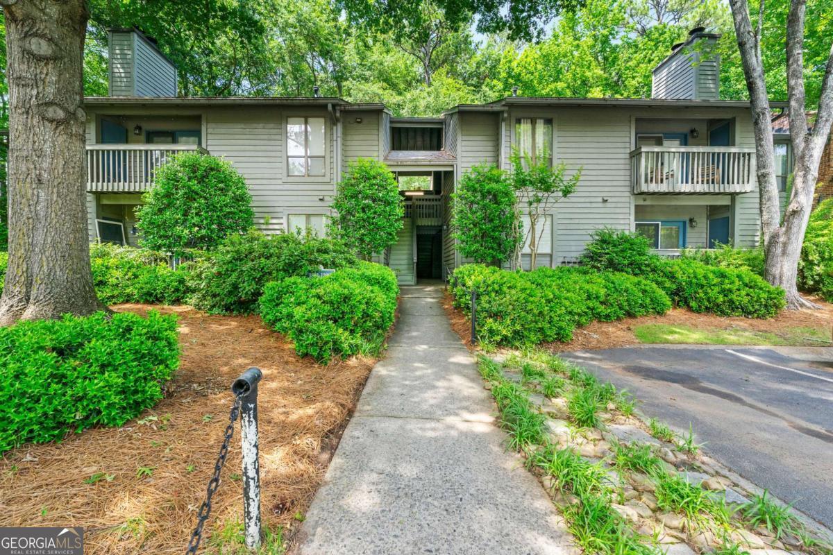 Tucked into a quiet, wooded condo community just outside downtown Decatur, this two-bedroom, two-bathroom home offers a low-maintenance lifestyle in a location that keeps you close to everything. With a smart roommate-style layout, both bedrooms sit on opposite sides of the unit and have direct access to a bathroom, ideal for shared living, guests, or a quiet work-from-home setup. The living room feels open and inviting, thanks to a vaulted ceiling and a wall of windows that brings in soft natural light. Just off the living area is a dedicated dining space and a separate laundry room for convenience. A brand new AC unit was recently installed, and the private balcony looks out over a quiet, wooded view, one of the many details that give the home its easygoing, relaxed feel. The community itself is shaded by mature trees and professionally landscaped, giving it a peaceful, park-like setting. Grocery stores and restaurants are just across the street, and Medlock Park is a few blocks away. Emory University is just minutes from the front door, and even better, an Emory shuttle stop is just down the street, offering free rides to campus and making this location especially convenient for anyone commuting to the Clifton Corridor. Downtown Decatur is just over a mile away, with MARTA access, local festivals, and some of the best food and coffee shops in Atlanta. Whether you're looking for a comfortable home base or a rental-ready investment, this condo makes life simple, and that's what makes it special.