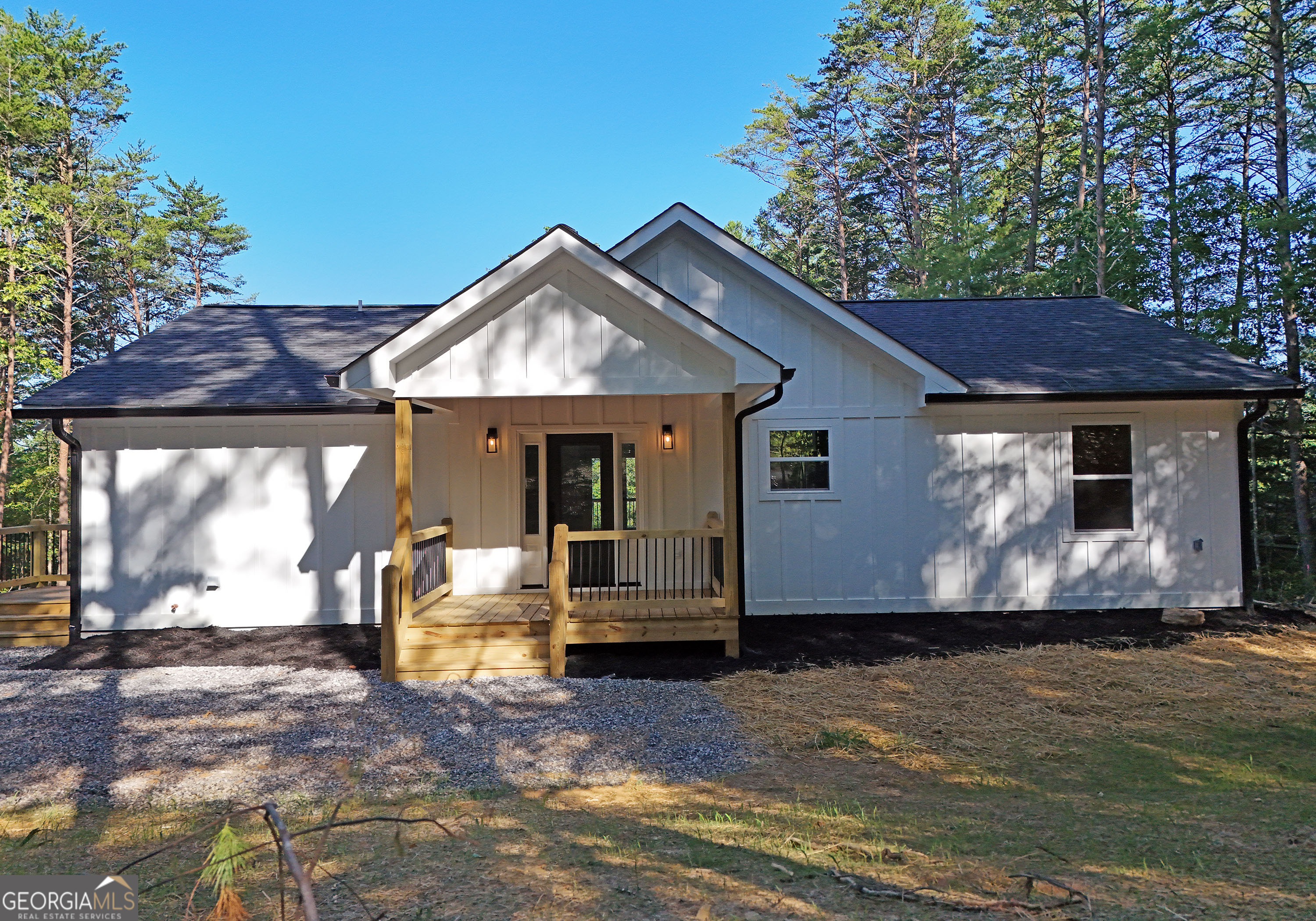 Your Blue Ridge mountain adventure starts here! This brand new, one-level ranch home offers the perfect blend of modern conveniences and a quiet, rural setting. Situated on 1.2 acres, you'll have plenty of room for whatever your heart desires. The front porch provides a great "welcome home" with its wood ceiling, warm porch lights, and glass front door. Inside, you'll find soaring ceilings and a space filled with natural light. Luxury vinyl plank flooring, rustic wood beams, recessed lighting, and shiplap accents combine to make this home something special. The kitchen is sure to delight with its warm-toned cabinets, stone counters, stainless steel appliances, and island with breakfast bar. Beyond, the family room is anchored by a cozy fireplace and French doors that open onto a private back deck. The split bedroom plan ensures privacy for everyone. The oversized primary suite features dual vanities, a spacious step-in tile shower, and a generous walk-in closet. The family foyer / mud room includes your laundry space and several built-in shelves to drop off your hats, jackets, and shoes. This home boasts a great location too, within easy distance to all the area's greatest attractions, so there's no shortage of activities to enjoy. Indulge in the numerous dining, shopping, and entertainment options in downtown Blue Ridge, go fishing or kayaking at Blue Ridge Lake, hike Brasstown Bald, or enjoy streams, waterfalls, and wildlife from the many hiking trails in the area. Pick apples at Mercier Orchards, go ziplining, horseback riding, ride ATVs, or relax at one of the area's great wineries.