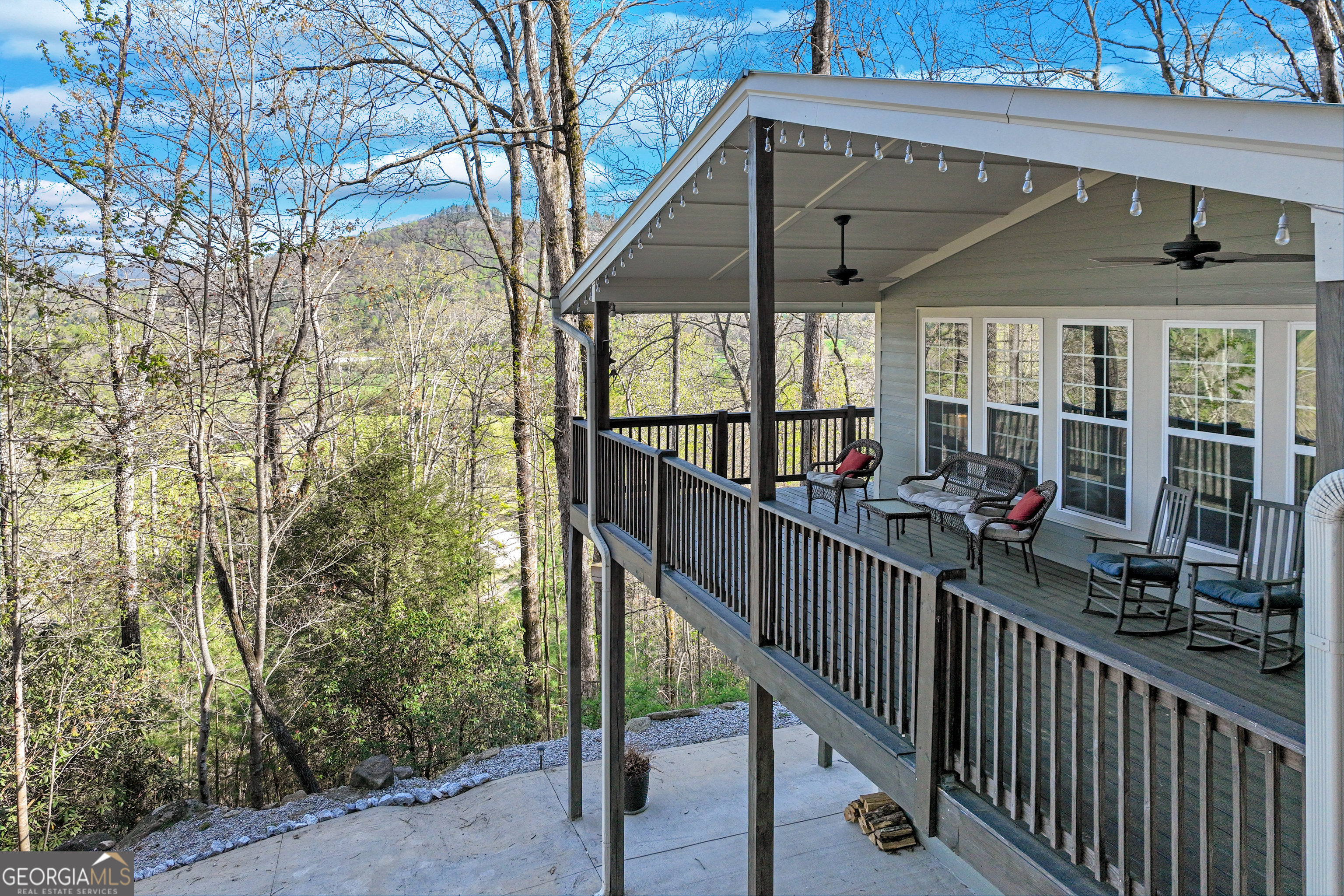 Private Mountain Retreat in Desirable Wolffork Valley! Escape to peace, privacy, and picture-perfect views in the heart of beautiful Wolffork Valley. This hidden gem sits on 1.1 acres bordering US Forestry land-offering rare seclusion just 10 minutes from the charming town of Clayton. A brand-new concrete driveway welcomes you to this delightful surprise perched on a gentle rise, featuring Hardie plank siding, quality trim, and a metal roof built for low-maintenance living. Inside, you'll find the open-concept great room is warm and welcoming with vaulted ceilings, wide plank ceramic tile floors, a cozy gas fireplace, and abundant natural light. The state-of-the-art kitchen boasts custom cabinetry, stainless steel appliances, a walk-in pantry, gorgeous granite countertops, and a large island with a breakfast bar-perfect for casual meals or entertaining. The main level includes kitchen, living, dining, and two spacious bedrooms and a lovely bathroom with a double vanity completes the main level. Downstairs, the walk-out lower level expands your living space with a large family room anchored by a charming pellet stove that can heat the entire home. A third bedroom, full bath, and convenient laundry area complete this level. The drive-under garage and carport are more than practical-they double as a fantastic workshop or "man cave," fully equipped with built-in storage, shelving, and room for all your projects. And then there's the showpiece: a massive, vaulted-ceiling porch where you'll spend endless hours surrounded by nature, watching wildlife, and taking in the stunning seasonal views of the valley and surrounding mountains. Located just minutes from farm-to-table restaurants, art galleries, boutiques, and antique shops in downtown Clayton-and surrounded by outdoor adventures like hiking, fishing, horseback riding, and three nearby state parks-this home has it all.