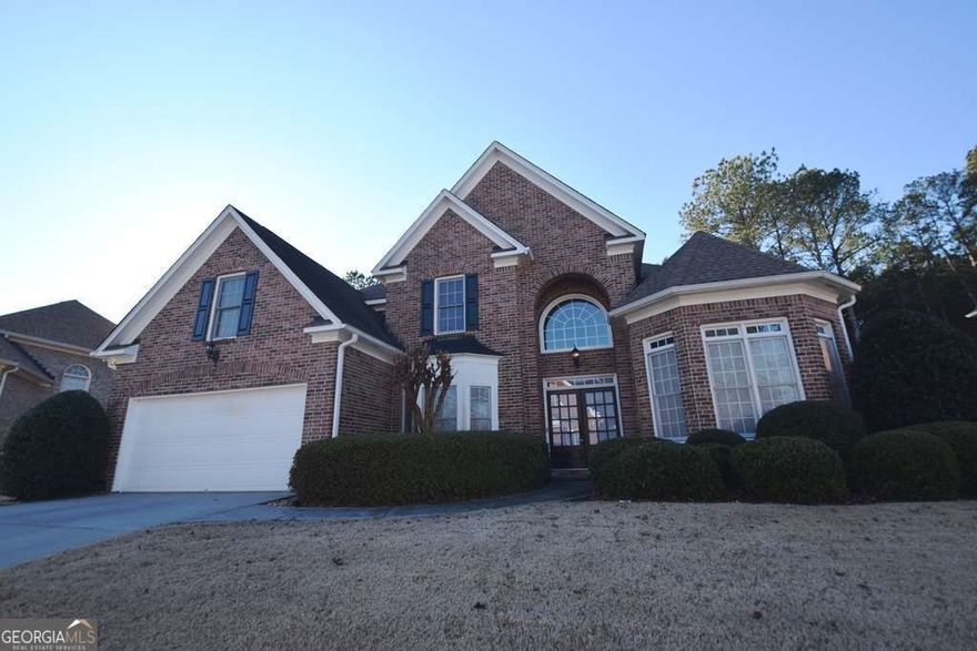 Welcome to 11130 Donnington Drive, a stunning 4-bedroom, 3.5-bathroom home nestled in the prestigious Estates at Wellington neighborhood of Johns Creek, Georgia. This beautiful brick-front home offers over 3,400 square feet of living space and is located in a well-maintained, mature swim-tennis community known for its excellent schools and atmosphere.    The home features a thoughtful two-story design with a primary suite on the main level, including a luxurious en-suite bathroom with a double vanity, soaking tub, and separate shower. Enjoy preparing meals in a fully equipped kitchen with stone countertops, stained cabinets, a pantry, and a kitchen island, all with a view to the family room. High ceilings, an open-concept dining room, and a cozy living room with a gas-log fireplace create an inviting ambiance. The home offers an attached two-car garage, a main-level laundry room, and energy-efficient double-pane windows.  Situated on a level, landscaped lot with a private backyard, this property is perfect for relaxation and outdoor entertainment. Residents have access to a homeowners' association, a community pool, tennis courts, sidewalks, and streetlights for added convenience and enjoyment.    Located in the heart of Johns Creek, this property is close to top-rated schools, including Abbotts Hill Elementary, Taylor Road Middle, and Chattahoochee High School. With nearby shopping, dining, and recreational opportunities, it offers the perfect balance of suburban comfort and urban accessibility.
