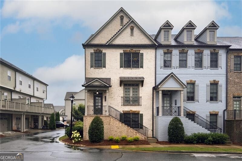 Welcome to this exceptional end-unit townhome in the sought-after Skyland Brookhaven community, showcasing the largest floor plan available and one of the most desirable locations in the neighborhood-privately nestled among green space and just moments from Dresden Village, PDK, and a vibrant array of shops and restaurants. Inside, soaring ceilings and gleaming hardwood floors create a warm, inviting atmosphere, while an open-concept layout seamlessly connects the living, dining, and kitchen areas for effortless everyday living and entertaining. The family room features a gas fireplace flanked by custom built-ins and is bathed in natural light from expansive windows. The chef's kitchen is a standout, complete with a generous quartz island, walk-in pantry, and ample space for casual dining or morning coffee. A Juliet balcony off the dining area and a stylish powder room complete the main level. Upstairs, the spacious primary suite is a true retreat, offering vaulted tray ceilings, additional windows exclusive to end units, and a spa-inspired bath with dual vanities, a soaking tub, and a separate glass-enclosed shower. The expansive walk-in closet features custom-designed built-ins, maximizing both storage and organization. The terrace level includes a versatile bonus room with a full bath-ideal for a guest suite, home office, or second living area. A rare blend of space, light, and location, this home is a standout opportunity in Brookhaven.