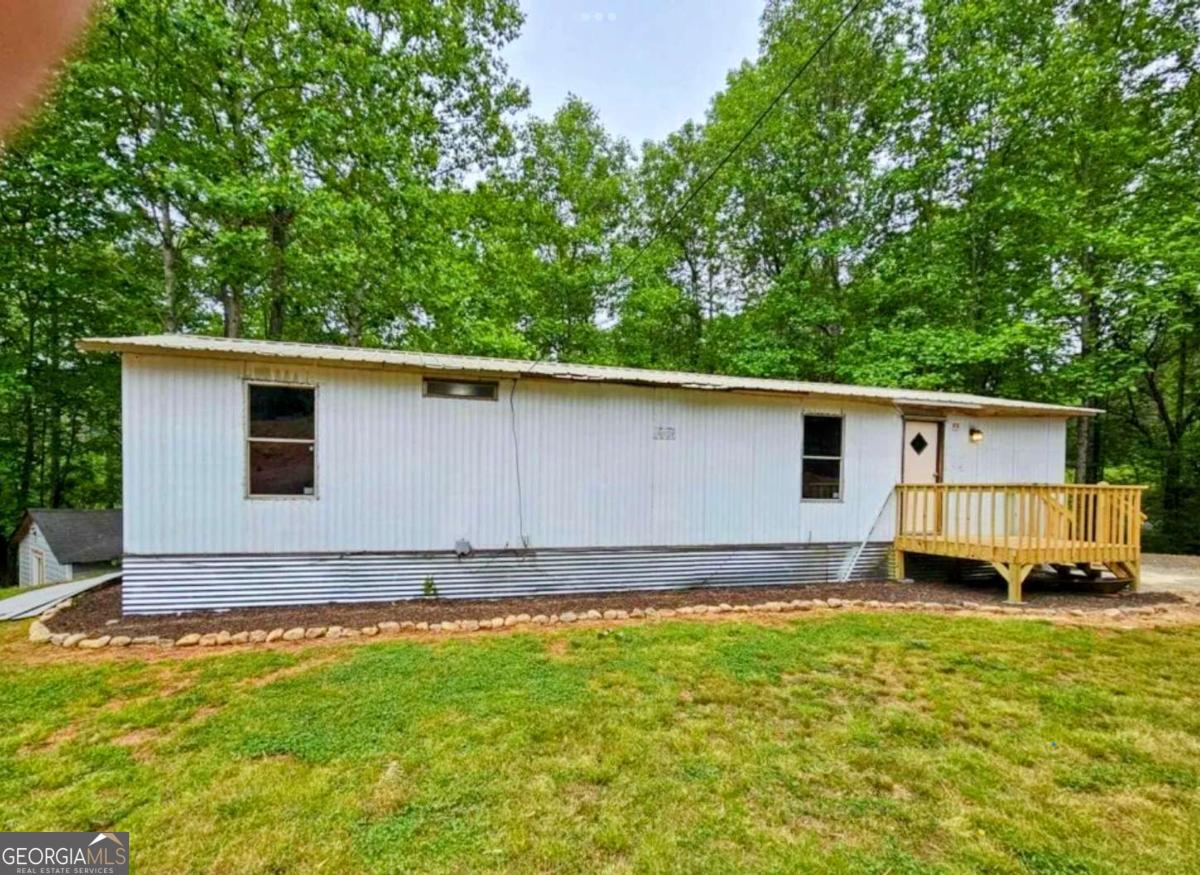 Rental Machine or Lakefront Dream! This 3 bedroom, 1 bath modular home sits just steps from the water and offers unbeatable lake views. The main home features 670 sq ft of living space, plus an enclosed rear porch that adds an additional 288 sq ft-perfect for a third bedroom, extra storage, or expanded living. Whether you're looking for a weekend getaway, full-time retreat, or short-term rental opportunity, this home is brimming with potential. Enjoy year-round comfort with a mini-split HVAC system, and take advantage of the spacious shed out back on a concrete slab-ideal for storage or even a future build-out. Bring your vision and your canoe! With some TLC, this lakeside gem could be transformed into a cozy escape or cash-flowing rental!