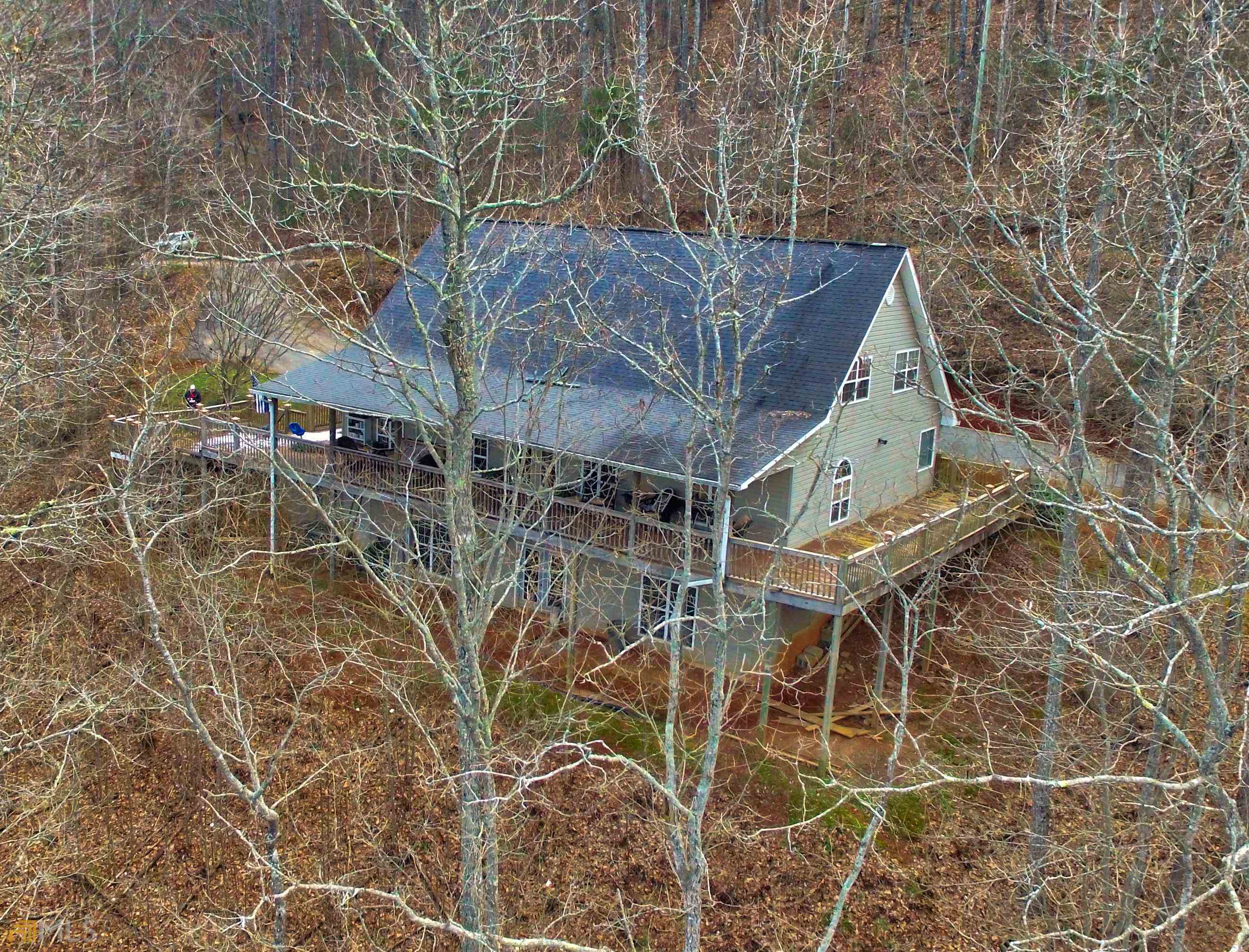 SPACIOUS home nearly 4,500 sq ft (finished & unfinished) located in a great community in beautiful Rabun Gap!! Home sits on 3 acres with a gorgeous seasonal view!! Easily open up view to year around. Enter from two car garage into mud room with large laundry area. The semi-open floor plan flows with hardwood floors through the living room, kitchen, and dining room. Master bedroom and bath on main floor along with a half bath. Upstairs features 3 bedrooms and a full bath. Partially finished lower level features an unfinished 2nd living room with fireplace and 2 unfinished rooms...1 bedroom and 1 bath is finished. Perfect family home!!