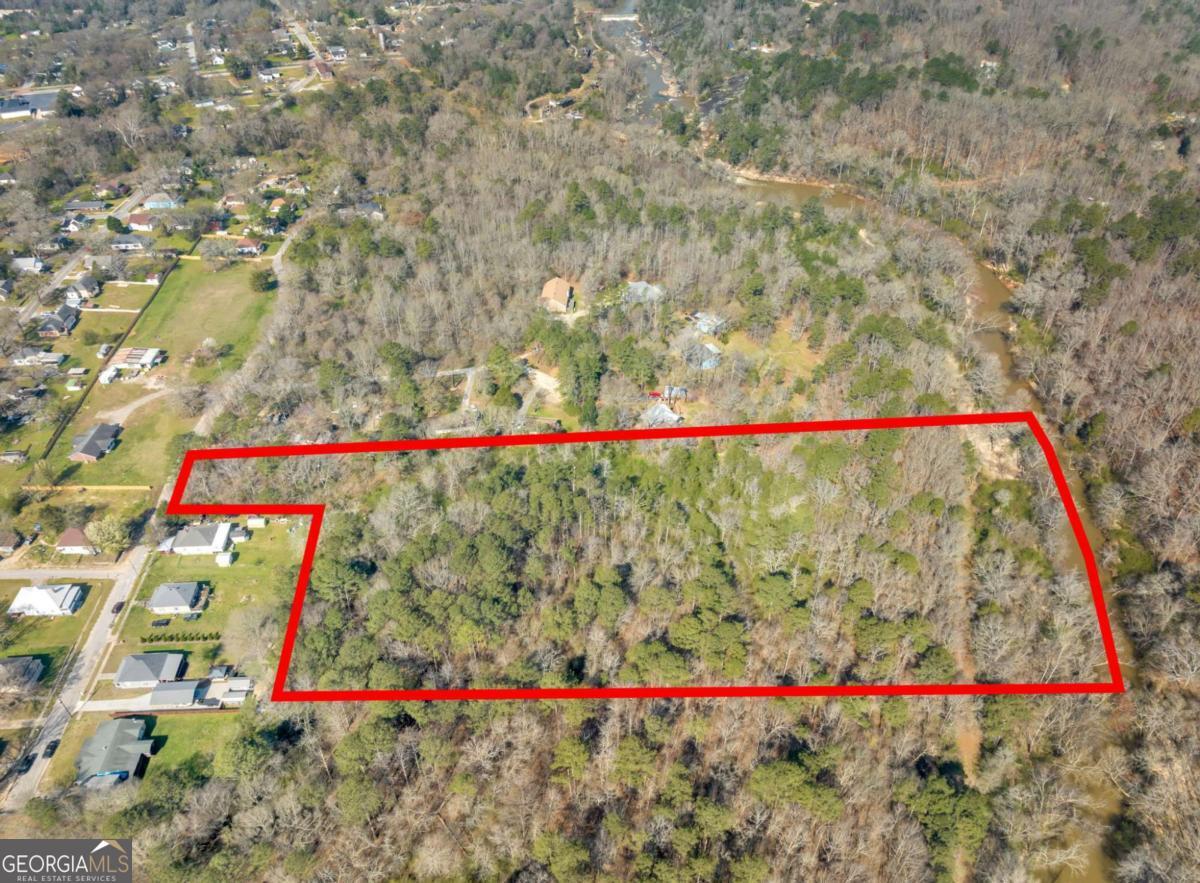 This 7.91 +/- acre land offers diverse possibilities, from building a custom home in the current R1 residential low-density zone to potential subdivision for a fast track or traditional development of four or more homes. Rockdale County's various zoning options provide flexibility for your specific builder needs. Furthermore, the location is dynamic with medical services, banks, supermarkets, shopping and major highways all within a five-mile radius. A visit could reveal a promising opportunity for your next project.