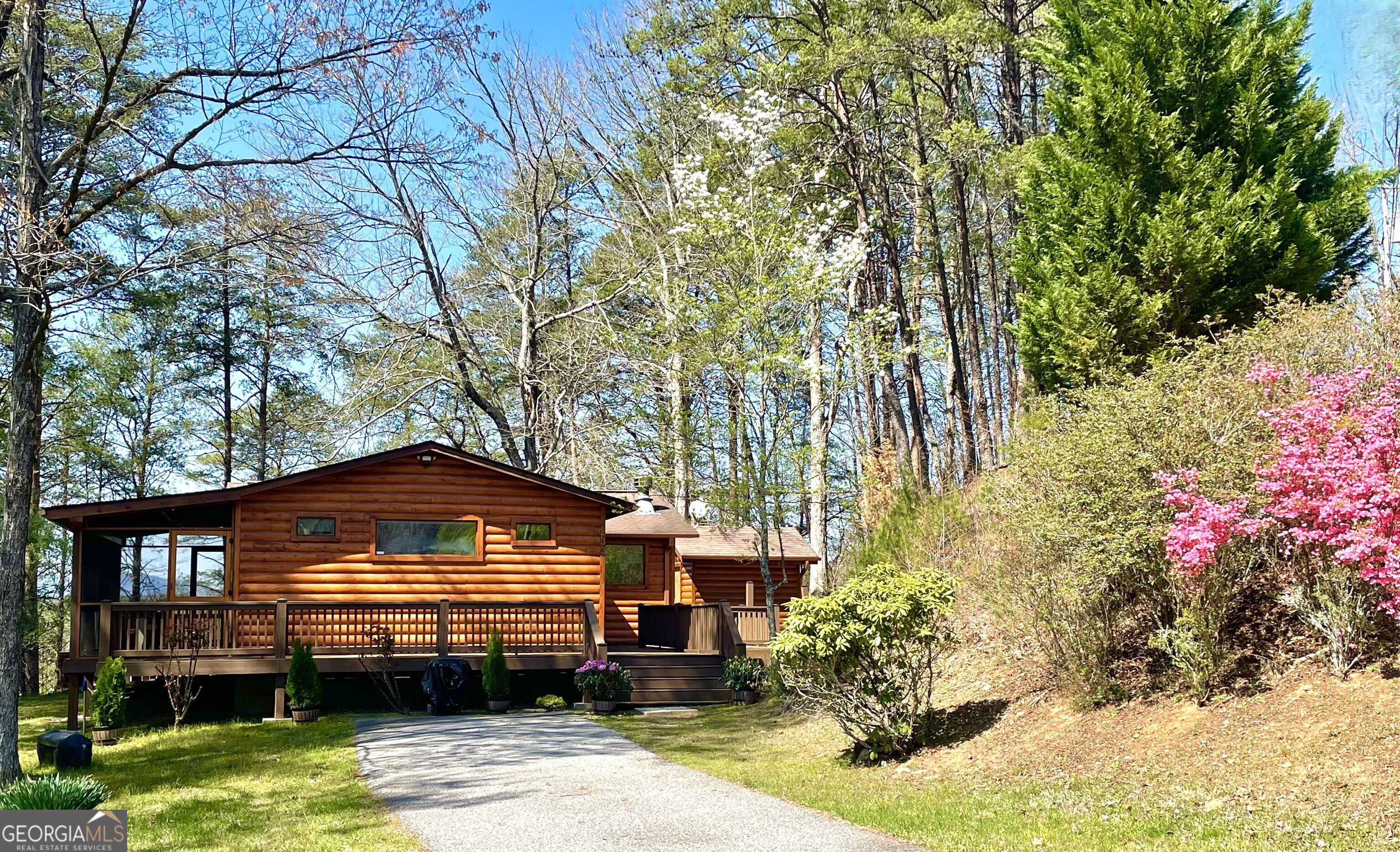 WOW!! Check out this price reduction!! Escape to this cute cabin cottage nestled in the serene surroundings of Mineral Bluff, just a short walk to Ron Henry Horseshoe Bend Park & the Toccoa River. Offering the perfect blend of rustic charm and modern comfort, this 2-bedroom, 2-bath home is an ideal mountain getaway. Only 5 minutes to McCaysville/Copperhill restaurants, shopping & entertainment. 20+- mins to historic dwntwn Blue Ridge. Inside, the magazine-worthy interior features hardwood floors and tongue & groove walls throughout, creating a warm and inviting atmosphere. The sun-filled primary suite is a true retreat, offering ample space for a reading nook, workout area, or cozy daybed. Both bedrooms boast ensuite baths, making this home ideal for personal use or a rental investment. The open-concept living area and kitchen are bathed in natural light, featuring ample cabinetry and a classic wood-burning fireplace, perfect for cozy mountain evenings. Step outside to expansive wraparound decking, where you can take in stunning mountain views and entertain guests in multiple outdoor living spaces. For a truly unique experience, retreat to the screened-in summerhouse, complete with a TV and wood-burning fireplace; a perfect spot for extra sleeping space in spring, summer, and even adventurous winter nights. After a day of exploring the mountains or tubing on the River, unwind in the covered hot tub, soaking in the peaceful surroundings and breathtaking vistas. Priced to sell and sold fully furnished (even includes the floating tubes!!). This charming turnkey mountain escape is ready for you. Just bring your toothbrush! Whether you're looking for a weekend getaway, Short Term Rental opportunity, or full-time residence, this North Georgia gem won't last long. Schedule your showing today!