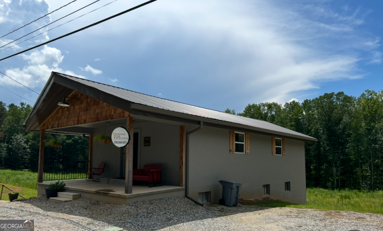 Endless possibilities await with this unique property in a prime Clarkesville location! Whether you're looking for a full-time residence, an income-producing investment, or a versatile live-work space, this property offers unmatched flexibility. Featuring 1,722 square feet of finished space, the upstairs is currently set up as a commercial office with a kitchenette, while the downstairs serves as a studio office space complete with a full kitchen. With a full bathroom, a half bath and two separate entrances, the layout easily accommodates multiple uses. Two parcels are being conveyed, totaling 3.34 acres, the property offers ample room to expand or customize to your needs. Just minutes from downtown Clarkesville and North Georgia Technical College, this is an ideal opportunity in a high-demand area!