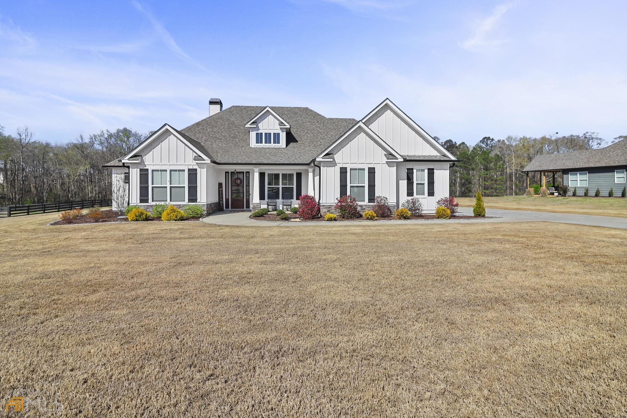 New Leaf Homes - Beautiful home inside and out!! Like new, built in 2019. 5 bedroom/4 bath home with open floor plan on an acre lot. The home features a gourmet beautiful bright kitchen with white cabinets, a large island, and granite countertops. Range with vent, and stainless appliances, opens to a large living room with a gorgeous fireplace. Immediately you will notice & Feel the spaciousness that the high ceilings, and windows galore. Hardwoods in main living areas. Master on main with 3 secondary bedrooms, 1 bed and full bath upstairs for office or guest to have their own space. The owner's Suite features a large soaking tub, a separate shower, and a large walk-in closet. The breathtaking backyard is full of upgrades. Hot tub on a concrete pad, Large inground swimming pool with tanning ledge, Saltwater system, concrete decking, utility building, and Beautiful Gazebo in the pool area for all your outdoor entertainment needs surrounded by 450 feet 4 rail farm fence with black wire. The home is perfect for entertaining. Beautiful home inside and out! 1 acre of private backyard. Expanded 2-car garage with extra storage. Minutes from Senoia, Peachtree City & Newnan. This is a MUST-SEE home!