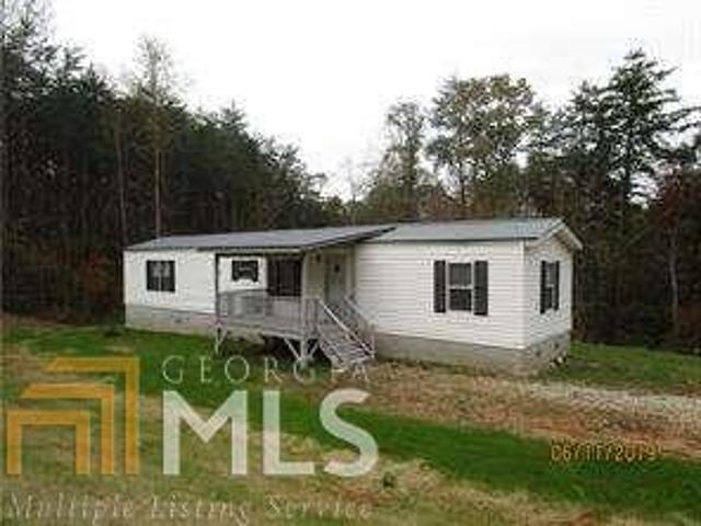 Affordable Like new single wide mobile home!! Great location!! 2 bedroom, 2 bath. Completely redone, laminate flooring throughout, new fixtures, paint, metal roof, nice deck to enjoy the gentle, usable acre lot. Appliances to include refrigerator.