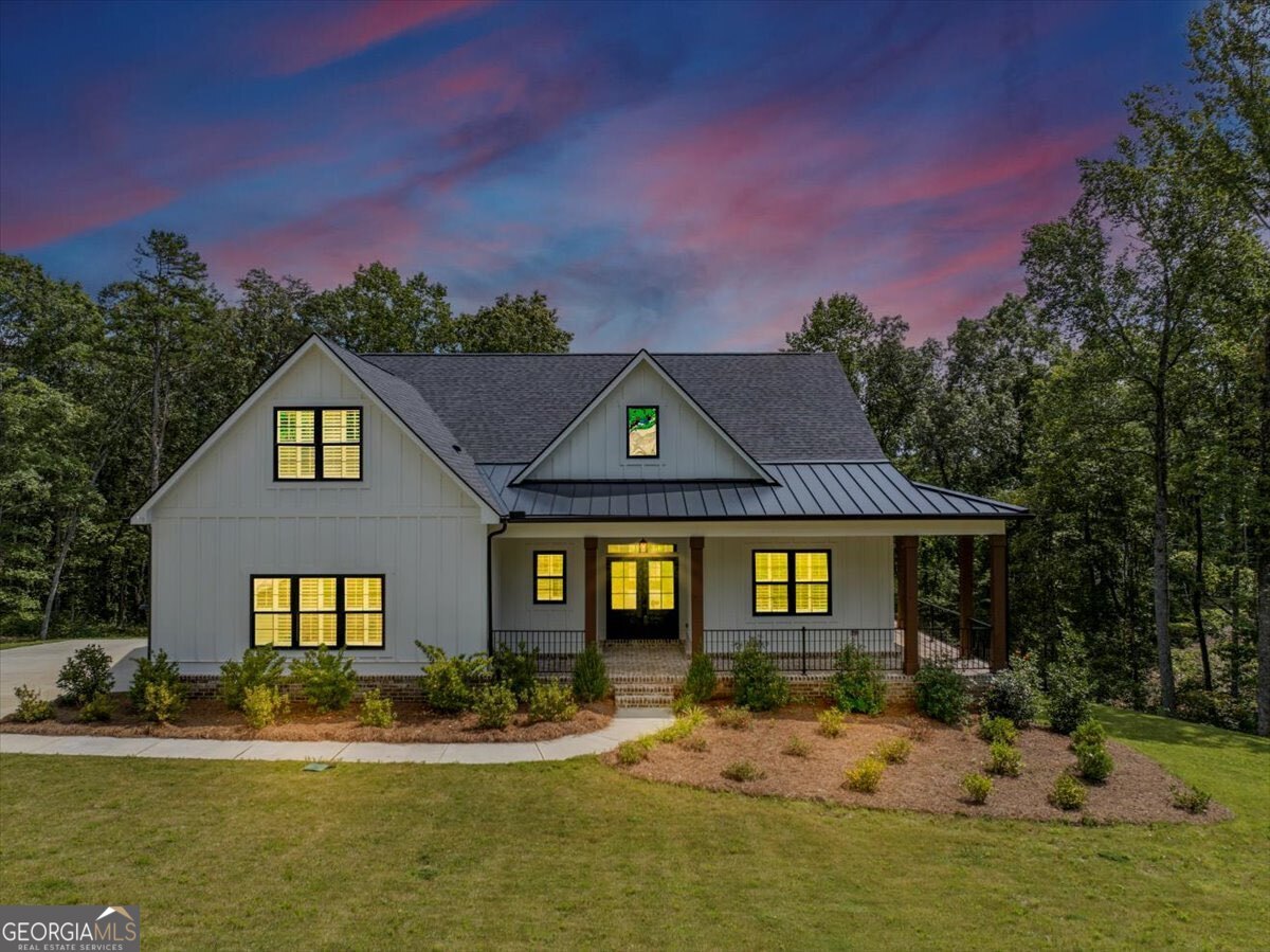 Step into refined elegance at this stunning Ball Ground residence. Designed with sophistication and comfort in mind, this home features soaring ceilings, expansive windows, and a seamless open layout that exudes modern luxury. The chef's kitchen is a true centerpiece, boasting quartz countertops, custom cabinetry, premium appliances, and a statement island ideal for entertaining. Retreat to the lavish owner's suite with its spa-like bath, complete with soaking tub, glass-enclosed shower, and designer finishes. Spacious secondary bedrooms and thoughtfully appointed living areas provide both comfort and style. Outdoors, enjoy a beautifully landscaped setting with ample space for private relaxation or elegant gatherings. Ideally located near charming downtown Ball Ground, this home offers the perfect balance of luxury living and everyday convenience.