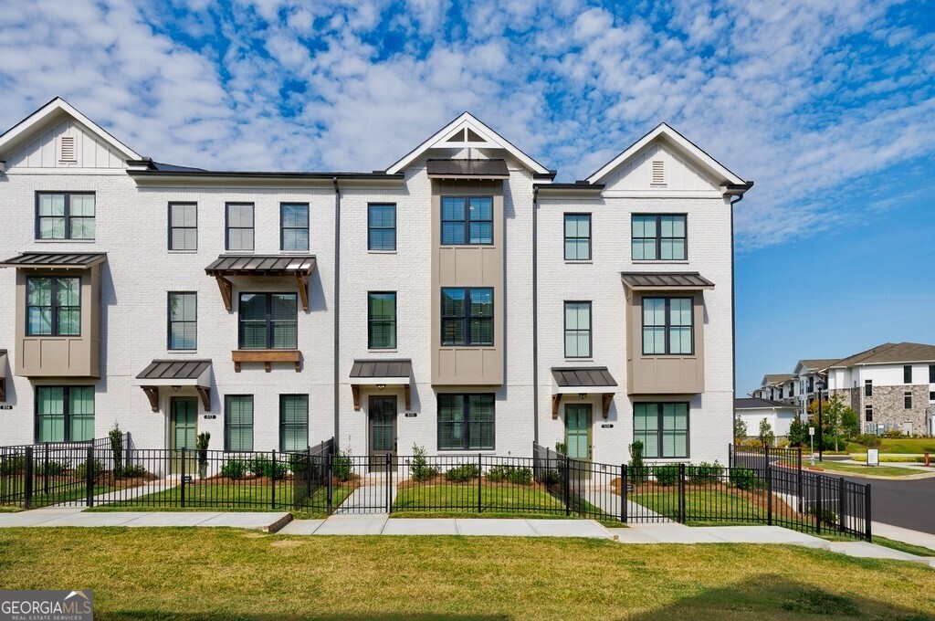 Welcome home to this stunning brand-new three-story townhome designed for both style and convenience! From the moment you step inside, you'll be impressed by the modern finishes, thoughtful layout, and natural light throughout. The terrace level offers a private bedroom with French doors, a full bath, and easy access to the two-car garage equipped with an EV charging outlet perfect for today's lifestyle. The main level is an entertainer's dream, showcasing an open-concept design with a gourmet kitchen featuring quartz countertops, soft-close cabinetry, and premium GE Profile appliances. Gather around the cozy gas fireplace in the spacious living room, enjoy meals in the dining area, or sip your morning coffee in the bright sunroom that opens to a private deck your ideal spot for relaxation. Upstairs, the owner's suite is a luxurious retreat with a walk-in closet, dual vanities, and a sleek walk-in shower. A third bedroom with its own bath provides flexibility for guests, a home office, or creative space. Laundry is conveniently located on this level as well. Complete with energy-efficient features, a fenced yard, and upscale details throughout, this home offers the perfect blend of comfort, convenience, and modern living. Don't miss the chance to be the very first to enjoy this beautiful new construction townhome schedule your tour today!