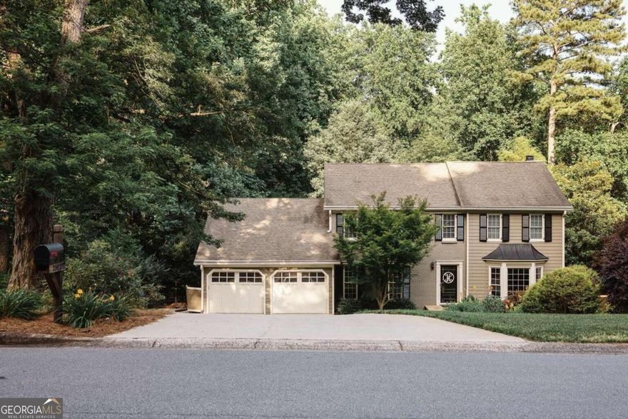 Situated in the prestigious Chimney Springs subdivision, this exquisite home boasts four bedrooms, five bathrooms, hardwood floors, and energy-efficient windows. The updated kitchen and spacious family room are perfect for entertaining, while the primary suite offers a serene retreat with his and hers walk-in closets. Two large bedrooms with ensuite baths are on the same floor conveniently located near a dedicated laundry room. Multi-generational guests will enjoy the main-level bedroom and full bath. With a walk-out basement, you have an oversized workout room, full bath, game room, media room, and entertainment area. A full workshop space is conveniently connected with a dedicated entrance. Outside, the large, flat backyard is perfect for outdoor activities. Located in the Tritt, Hightower, and Pope school districts, don't miss the chance to own this luxurious property!
