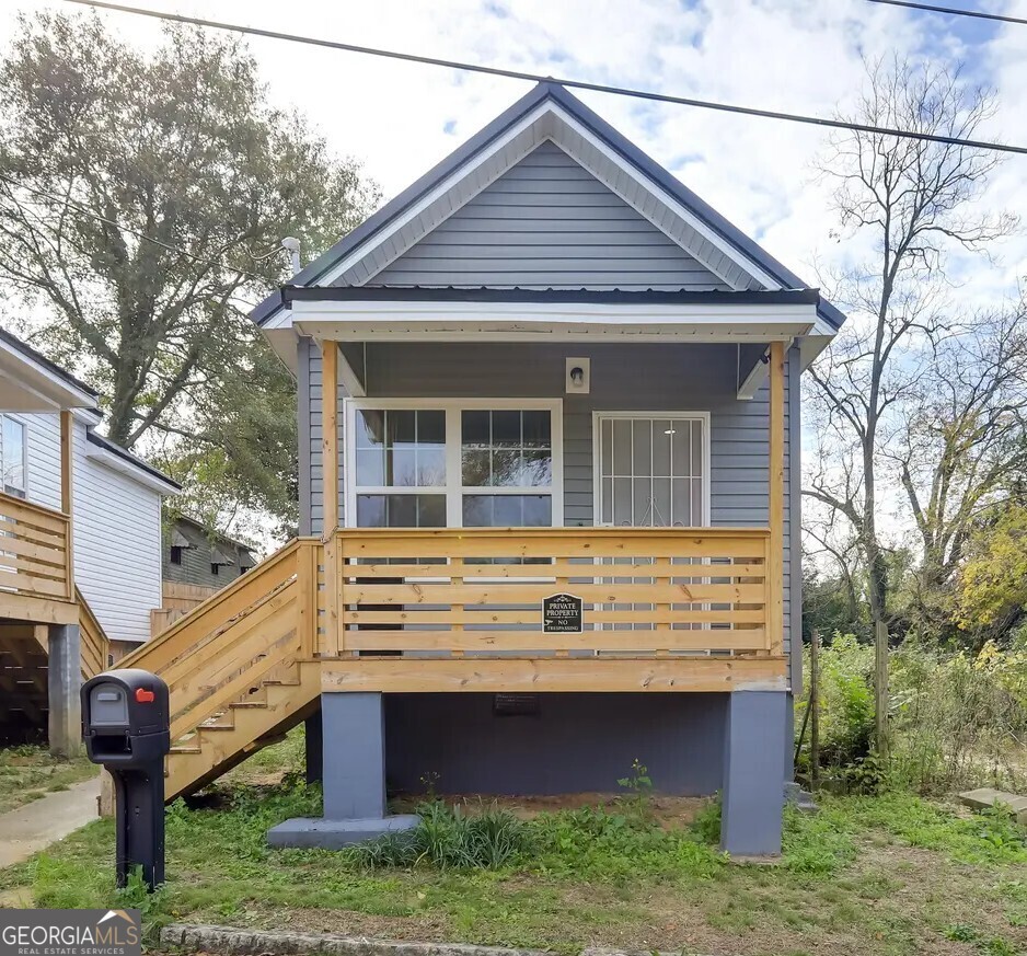 Investors, take a look!! This property is currently leased for $1400 a month until July 2026. The lessee (tenant) is a company that specializes in providing furnished corporate housing and short-term rentals to professionals. If you're looking for a beautiful, completely renovated AND furnished property with immediate cash flow, this is the one! Step into a perfect blend of historic charm and modern convenience with this beautifully renovated single-family home! Built in 1900, this stunning 2-bedroom, 1.5-bath residence has been thoughtfully designed for both space efficiency and luxurious comfort. Every detail has been meticulously updated in 2024, ensuring a turnkey experience for the next lucky owner. The home is equipped with smart technology, including a Wi-Fi-enabled thermostat, offering convenience and ease in daily living. Inside, new vinyl plank flooring flows seamlessly throughout, complemented by expansive new windows that flood the space with natural light. The full-size kitchen features granite countertops, stainless steel appliances, and a built-in microwave, all crafted for practicality and everyday ease. This home's transformation extends beyond its interior. With a brand-new roof, updated electrical and plumbing, new HVAC system, and a tankless water heater, every upgrade ensures peace of mind. Outside, embrace the beauty of Georgia's climate in your private, fenced backyard, beautifully landscaped for relaxation. Enjoy morning tea on the charming deck or take a short stroll to the serene green space and park at the end of this quiet street. Conveniently located near downtown Macon, you'll have easy access to an array of restaurants, shopping, museums, and entertainment. Plus, Tattnall Square Park, Mercer University, and Macon's dog parks are just around the corner. This home is a piece of history, brilliantly modernized for today's lifestyle and perfectly suited for professional temporary rentals. This gem in the heart of Macon is a ready-made investment with a signed lease already in place! Interested in having 2 instant cash flow investments? Check out 1408 2nd Ave... it's right next door!