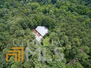 If you are looking for complete privacy an over 4 acres, you found it! The home is tranquilly set back off the road for perfect seclusion with enough acreage for a small farm. Current owners had some goats, pigs, chickens, cows and dogs. The house needs cosmetic work but is super large with 4 full bedrooms on the main level with the owners suite on a completely different side of the other secondary bedrooms. Full basement has a bedroom, full bathroom, living room with a fireplace, full kitchen, play room and plenty of unfinished areas to be used as storage, a workshop or made into additional living space.