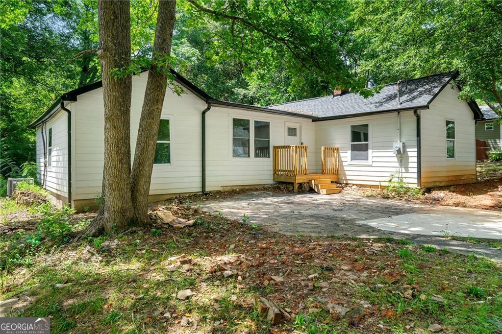 Check out this beautifully renovated home, only a few minutes walk from Downtown Newnan's restaurants and shops! This home is larger than it appears and boasts plenty of updates. Open the front door to gleaming new floors and tons of natural light throughout with all new windows. This home features a spacious open floorplan, connecting living, kitchen and dining rooms, perfect for entertaining friends and family. Whip up delicious meals in your chef-ready kitchen with white cabinets, sparkling granite countertops and new Stainless Steel Appliances. Relax in your private master with walk-in closet and refreshing ensuite bathroom. Enjoy the space of 3 additional guest bedrooms, full guest bathroom, convenient half bathroom and hallway laundry. Spend evenings relaxing on the new side deck overlooking your backyard. Or walk to it all; Lynch Park Pool, Boys and Girls Club, Downtown Bars, Restaurants and Shops. Don't miss out on the opportunity to make this renovated house your new home. Schedule a showing today and experience the best of Newnan living!