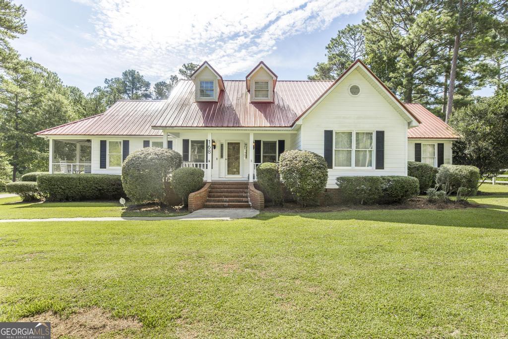 Looking for a home with ACREAGE, a POND, and a COUNTY location? You've just found it! This beautifully updated 3-bedroom, 2.5-bath home sits on nearly 4 acres in the county 441 by-pass-offering the best of peaceful country living with modern comforts. Step inside to find a spacious kitchen featuring granite countertops and updated LVT flooring that flows throughout the home. The large living room is ideal for relaxing or entertaining, complete with a wood-burning fireplace and custom built-in cabinets. Enjoy year-round relaxation in the sunroom, which opens to a sprawling back deck and a covered outdoor kitchen-perfect for gatherings. On the side, a screened-in porch provides the perfect view of your private, spring-fed pond, stocked with bass and bream. Additional features include: A detached shop/craft room with electricity and a window unit A huge RV shelter with 50-amp hookup Multiple storage buildings, including one with electricity A private dock for fishing A sprinkler system fed by the pond to keep the grounds green A top-of-the-line security system with full coverage and camera monitoring WiFi-controlled sprinklers The exterior is meticulously maintained, making this property truly move-in ready. This rare gem has it all-acreage, water, privacy, storage, and modern upgrades. Don't miss it! Call the listing agent today to schedule your private tour!