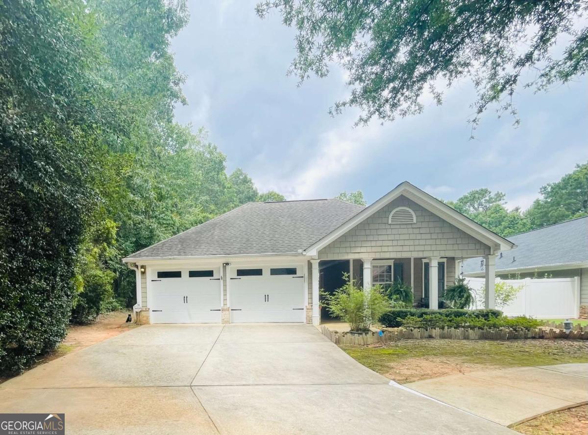 Located in Heron Bay Golf Country Club, south Atlanta's premiere resort-style community, this charming craftsman style home is situated on the course's 9th fairway! This very unique and highly sought after plan features three bedrooms and three baths, with the owner's ensuite and a second bedroom and bath being located in the main area of the home from the front porch, you'll enter into the private courtyard via a wrought iron gate, providing a unique and intriguing feature to the elevation. To your left is the ever-popular CASITA featuring a bedroom w/private bath overlooking the courtyard. This incredible feature offers lots of options, as the casita is private from the rest of the house and can be used as a teen/in-law suite, an office, a man cave, or for guests who come for an extended stay! So many options for this multi-functional area! The oversized Chattahoochee pebble stone patio in the private courtyard offers an inviting setting for private gatherings, or simply for enjoying the serenity and privacy of the outdoors in your own space! There are also stone walkways in the courtyard so that you can easily access the front or back yards. Just a few steps ahead, you will enter into the foyer of the main home, featuring a spacious family room/dining room with electric fireplace that opens up into the tiled sunroom with lots of windows and terrific views of the beautiful golf course! Off the sunroom, there is also a patio. The kitchen has granite countertops and stainless appliances (gas stove), a raised gathering bar and a breakfast nook. Pantry. In addition to the tiled sunroom, there is tile in all wet areas, including bathrooms, kitchen, and laundry room. This home is designed to provide privacy for all when retiring. The oversized owner's suite spans the left side of the house, with the sitting area/office nook overlooking the soothing views of the golf course. There's also a French door from the bedroom to the private courtyard. Then, on the other side of the kitchen, there's the secondary bedroom and bath. In addition to all that this home has to offer, the community amenities are unparalleled. The resort-style community offers an aquatic center with splash pool and dual slides, mushroom sprinklers, a zero entry pool for the kiddies, and a junior Olympic size swimming pool just past the front entrance to the community the convenience and enjoyment of our residents, there's also a smaller, intimate pool more centrally located in the community. Organized teams with plenty of tennis and pickleball courts. There's also a Dog Park and a Sports Park, in addition to nature trails throughout the community. Our premiere amenity is quite probably the Lakeview Park and pavilion, situated on the 1100 acre Cole Reservoir - perfect for kayaks, canoes, and non-gas powered watercraft. An added feature is that the Cottages & Villas communities include mowing, edging, trimming, exterior sprinkler, trash, and termite bond, not to forget the private clubhouse where there are events for the C&V residents that are in addition to those sponsored by the Master Association. There's so much to choose from - and it's all included in your assessments.