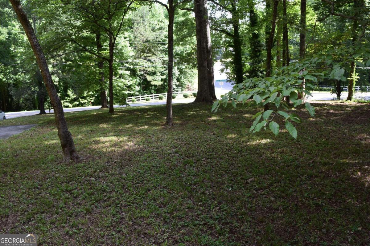 Discover your perfect retreat just ten miles from downtown Douglasville! This beautifully maintained 3-bedroom, 2-bath modular home sits on a level acre lot, offering both space and tranquility. This home is in excellent shape, exceptionally clean, and ready for you to move in and enjoy. Enjoy cozy evenings by the fireplace in the living area. Featuring a newer roof, new deck, new steps, a newer A/C unit, and a newer refrigerator. It has plenty of cabinet space throughout the home. It has a LONG paved driveway and parking pad. Convenient Location: Close to downtown Douglasville, offering easy access to shopping, dining, and entertainment options.