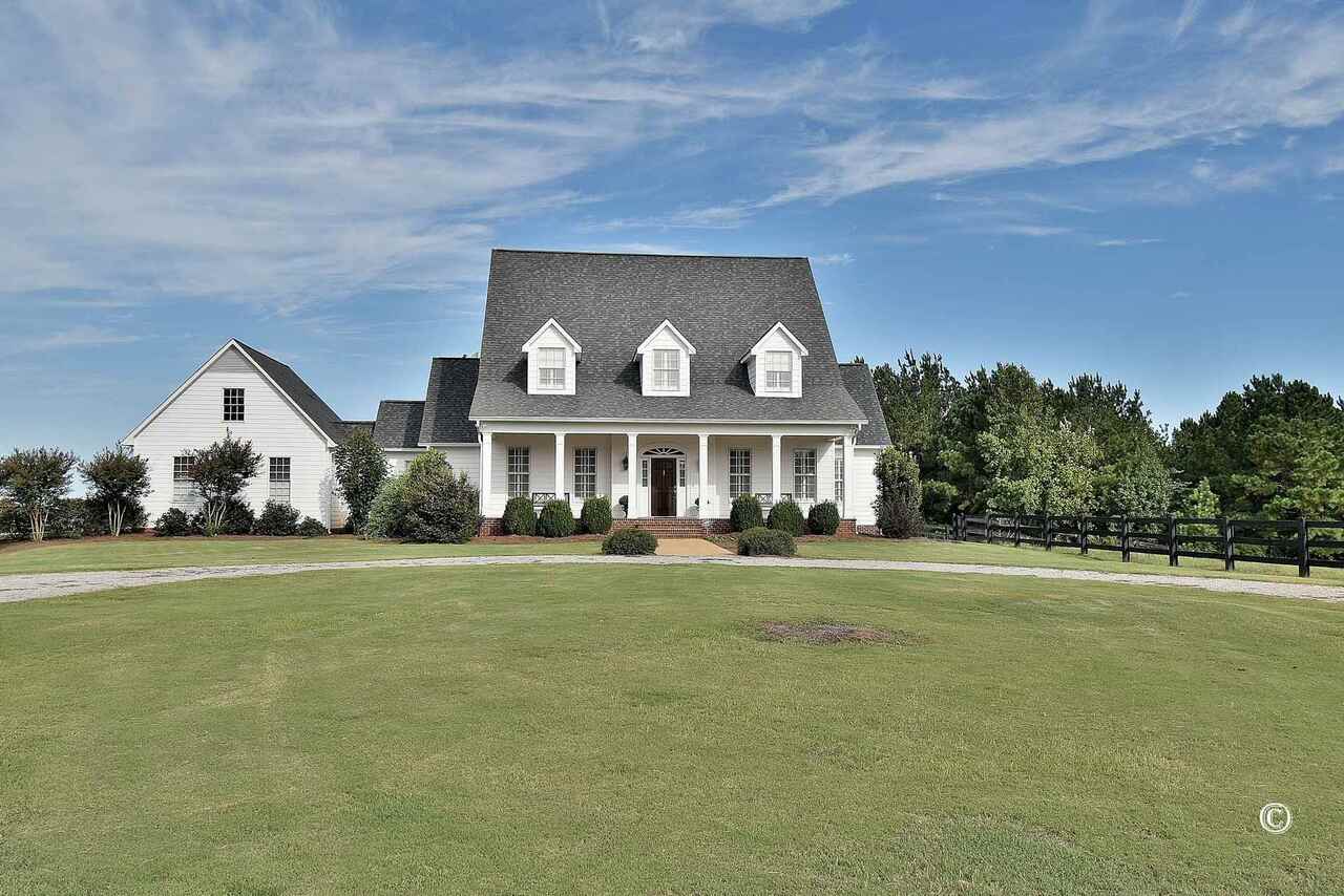 Traditional farm house situated on hill top overlooking 62 acre cattle farm. Mostly open land, fenced and crossed fenced. Board fence at entrance, along drive and around the house. Custom cabinets in kitchen with granite tops, sunken living room with heart pine floors and exposed beams, built in cabinets, master suite on main floor, 2 car garage, Hardee plank siding, approximately 800 SF finished in basement with over 1000 sf unfinished. 40 x 78 pole barn with 16' wings off each side. --- Additional acreage available --