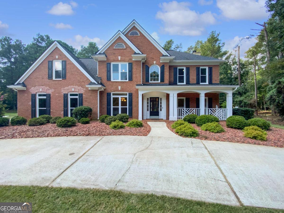 Spacious 5-bedroom, 2.5-bath brick-front home with timeless curb appeal and a welcoming front porch. Inside, the family room features a cozy fireplace and built-in bookcases, while a bright sunroom offers the perfect spot to relax. The eat-in kitchen boasts solid surface countertops and ample cabinetry, flowing seamlessly into the dining and living rooms for easy entertaining. Upstairs, the primary suite impresses with a tray ceiling, two walk-in closets, and an updated ensuite bathroom complete with dual vanities, a soaking tub, and a separate shower. Outdoor living is easy with a private patio, and the side-entry garage adds convenience and charm.
