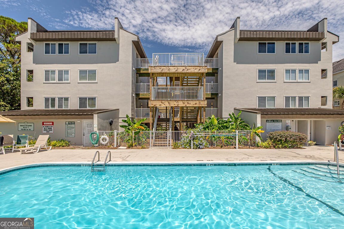 Live your coastal dream in this beautifully remodeled 2-bedroom, 2-bath condominium with 822 sq. ft. of stylish living space in a gated beachfront community. Step inside to discover smooth ceilings with crown molding, fresh updated light fixtures, and shiplap-accented walls paired with a tongue-and-groove kitchen ceiling for a modern coastal vibe. The fully furnished interior features custom barn doors, new flooring, and a walk-in tile shower in the primary bath. Relax and entertain on your covered private deck, just steps from the sand. Enjoy peace of mind with a building that's had extensive exterior renovations completed in 2024. Community perks include pool, covered parking, storage closet, and the security of a gated entrance-all in a prime location directly on the beach. Provides rental income for those seeking to invest. Don't miss this rare opportunity. Beachfront living has never been so affordable. Walk Through Video: https://youtu.be/NZ_Uoxa8Ncg?si=CAY7GV9viKlrzyIF