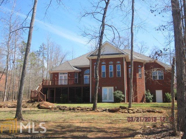 Owner has transferred, and this is a deal!!! WOW, Wonderful completely custom California style dream home. You absolutely must see the inside of this home to see the money that the owner spent finishing the home. Situated overlooking a 4 acre pond from every room of the house in one of Oconee's finest lifestyle subdivisions - A GOLF/SWIM/TENNIS COMMUNITY. It has the feel of a southern plantation as you drive through the neighborhood and see the golfers at leisure on a beautifully maintained course, pass by the pool and tennis courts and families strolling along the way. Fish the lake from your lawn or small boat or sit on the deck and take in the beautiful foliage and wildlife. This beautiful custom built all brick home is an extra large one level main floor