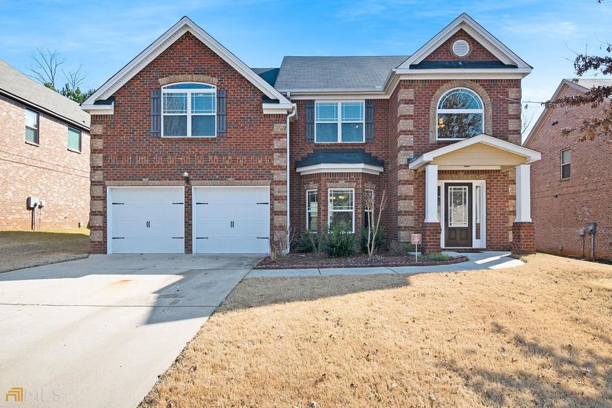 Spacious brick home in Slater Mill, a gated community. TONS of natural sunlight, open concept, coffered + cathedral ceilings! Fireplace, hardwood floors, bedroom and bathroom on the main level! HUGE master suite upstairs! This house is move-in ready!