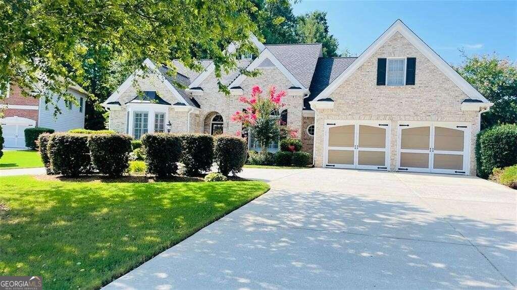 Welcome home! Beautifully spacious ranch home in pristine Lakefield Manor subdivision located in West Cobb! This beautiful 4 bedroom 3.5 bath brick front ranch home is situated on a level, corner cul-de-sac lot. The home has a spacious circular driveway along with a 6-car capacity driveway and 2 car garage. Foyer entrance boasts of high ceilings, with views to the separate dining room. Main level also features roommate floor plan with relaxing owner's suite on one side of the home including large ensuite bath, double vanities, separate garden tub and shower and large walk-in closet; while the other side of the home includes 2 additional bedrooms with Jack and Jill bathroom. Family room includes gas log fireplace, built in bookshelves and coffered ceilings and a wall of windows providing plenty of natural light. Rounding out the main floor is an eat-in kitchen with stainless steel appliances, granite countertops and pantry, an office/library (also with built in bookshelves) and the laundry room. Upper level includes the 4th bedroom and full bath perfect for a private guest or teen suite or extra storage space. Private, nicely landscaped backyard includes large patio perfect for relaxing and entertaining. The home is also equipped with a sprinkler system for the front and back yard. Neighborhood amenities include two swimming pools, tennis courts, central park, two lakes (stocked with fish) and walking trails. The community is close to shopping and is less than 3 miles from Kennesaw Mountain trails and hiking. Marietta Square and Battery Atlanta are also nearby. Schedule your appointment today to see all this home has to offer!