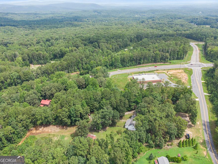 Great opportunity in this rapidly growing Cherokee County. Zoned General Commercial and located at the intersection of GA State Hwy 20 and Hwy 108 (Fincher Rd) between Canton and Cartersville next to newly constructed Dollar General Store.. Lake Allatoona is close by. Adjacent properties are also zoned general commercial with possible opportunity to assemble other tracts. This would be a great location for a gas station, storage facility, dry storage for RV's and boats, etc.... possibilities are endless. There is a farmhouse nestled on this 4.88-acre property in Sutallee that offers the perfect blend of rustic charm and commercial potential. With 4 bedrooms, 2.5 bathrooms, and a spacious 3,000 square feet, this property is a true gem. Step inside and be enchanted by the farmhouse's inviting ambiance, complete with a cozy family room featuring a fireplace and exposed beams that exude warmth and character. Beyond the charming living spaces, the property boasts a barn, pasture, and an abundance of fruit trees, creating a picturesque mini-farm setting. But the real draw is the property's commercial zoning, making it an exceptional opportunity for those seeking to establish a thriving business in a serene, countryside location.