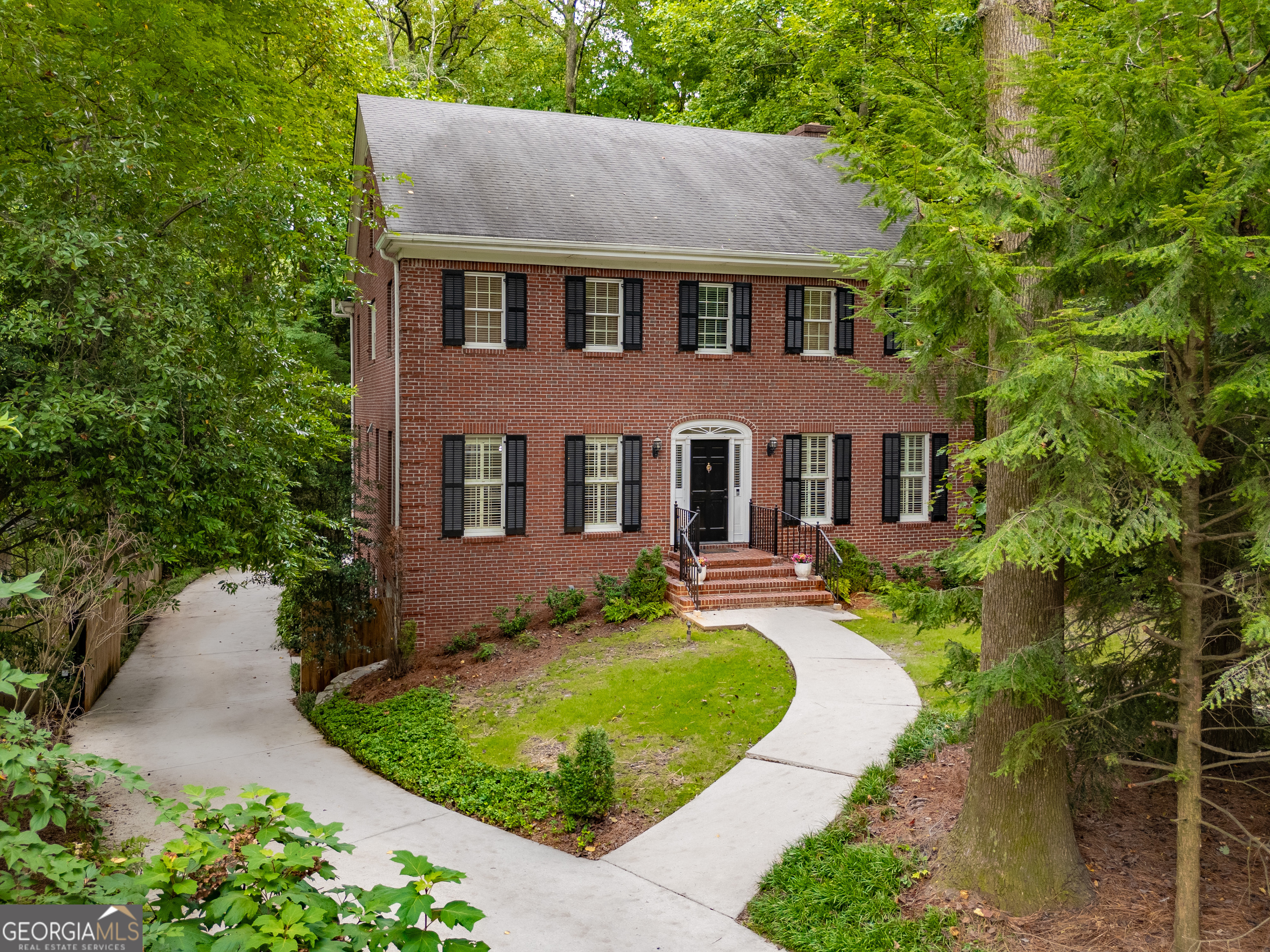 Exceptional, spacious 4BR/2.5BA four-sided brick home in coveted Parkwood neighborhood! Walk to Dancing Goats coffee, Toy Park, Chai Pani & Taqueria del Sol, plus East Lake MARTA for easy access to Mercedes-Benz Stadium & downtown Atlanta. Equidistant from vibrant downtown Decatur dining scene & trendy Oakhurst Village w/ sought-after CoD schools. Tight-knit, serene neighborhood where neighbors stay for generations hosting year-round gatherings - rare opportunity as only few homes sell annually! Stunning foyer w/ double glass doors leads to large LR w/ soaring wood beams & cozy gas FP flowing seamlessly to gourmet kitchen featuring 5-burner gas range, SS appliances, generous pantry, dedicated coffee bar & abundant storage perfect for entertaining. Formal DR accommodates dinner parties while eat-in kitchen opens to expansive deck overlooking private 0.45-acre wooded oasis - your own backyard retreat! Large office with built-ins perfect for remote work. Luxurious primary suite w/ tray ceiling overlooks established forest, featuring spa-like bath w/ custom walk-in closet, double vanity w/ storage, relaxing soaker tub & walk-in shower w/ dual heads. New hardwoods upstairs complement beautiful stained wood doors throughout. Three guest BRs share large hallway bath, one w/ dual closets & charming window seat. Convenient upstairs W/D hookups make family life easier. Finished basement transforms daily living w/ two large bonus rooms (new LVP flooring), one w/ fireplace - endless possibilities for home theater, gym, additional office, playroom or teen hangout - plus storage. Opportunity to add full bath downstairs. Spacious attic offers potential for additional finished square footage. Outdoor paradise features wooded backyard sanctuary perfect for morning coffee or evening beverage. Generous parking includes concrete pad ideal for basketball, games & outdoor fun, plus covered carport & 2-car garage w/ epoxy flooring. Recent premium updates: new high-grade HVAC systems, classic lighting throughout, crown molding, elegant plantation shutters. Every detail honors timeless architecture while meeting today's lifestyle demands. This isn't just a home - it's your gateway to the quintessential Decatur lifestyle where community, convenience & tranquility perfectly intersect!