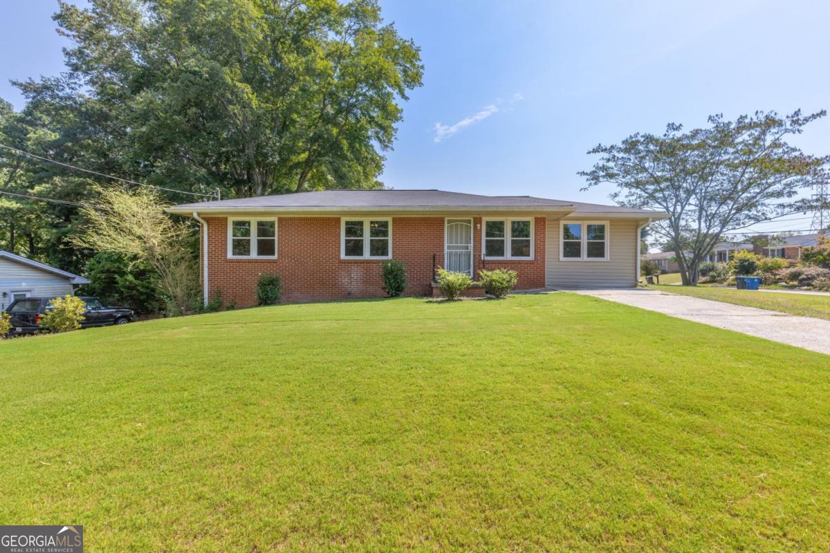 This updated ranch sits on a picturesque corner lot less than a mile from downtown Kennesaw and just 2 miles from KSU campus. Inside, you'll find real hardwood floors throughout and a bright living area that flows into the kitchen with white cabinetry and new stainless steel appliances. The main level offers 3 bedrooms plus a spacious bonus room-ideal as a 4th bedroom, great room, or flex space to fit your needs. The level, freshly sodded yard provides plenty of room for pets, play, or outdoor gatherings. A full basement adds storage and potential for future expansion. Recent improvements include newer windows, roof, and HVAC system, making this home truly move-in ready. Whether you're looking for an investment property, a student home, or simply a well-located residence, this one checks all the boxes. Easy access to Kennesaw amenities, hospitals, KSU, and I-75.