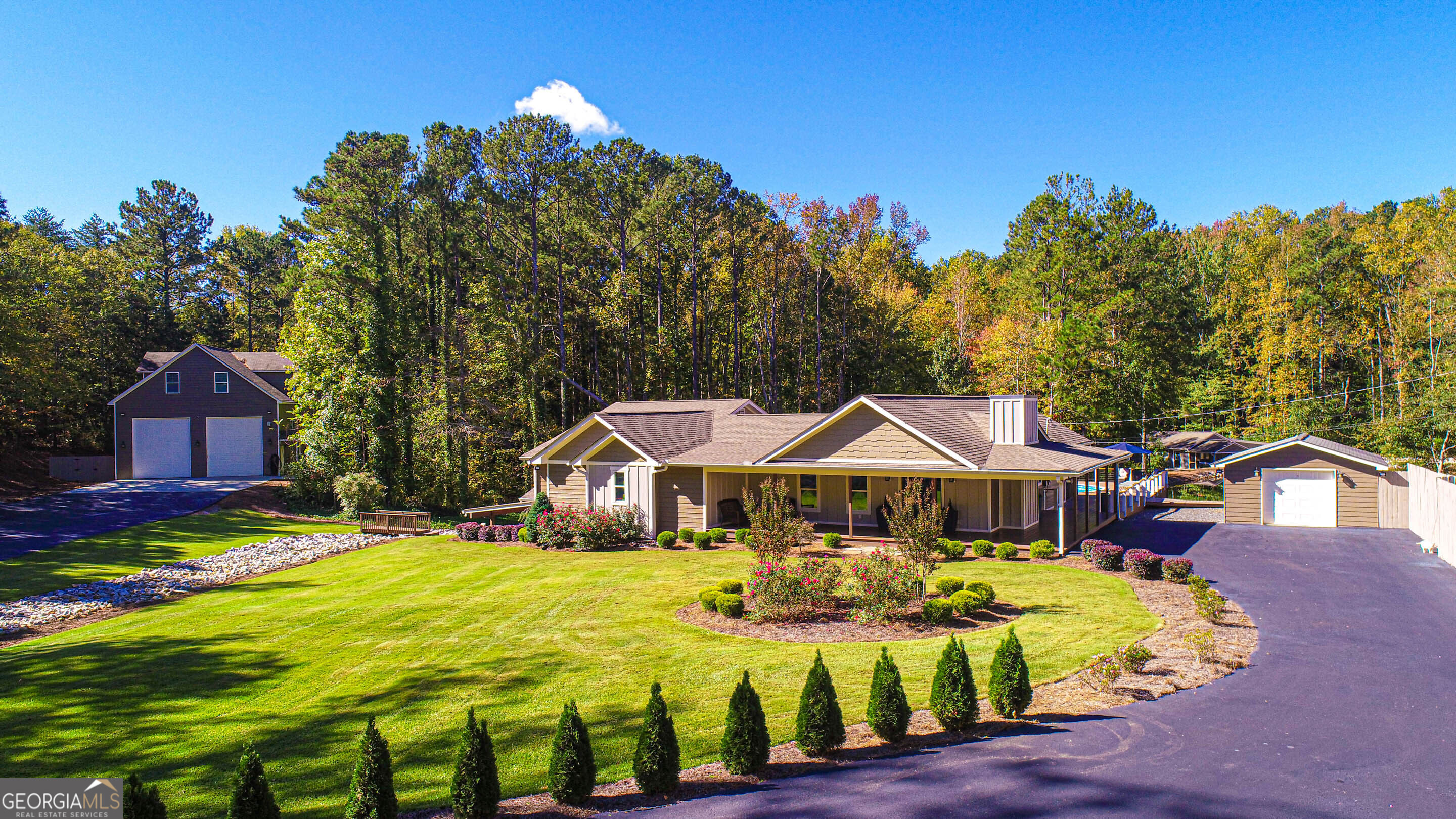 Quiet, Secluded Estate with Business Potential - McDonough, GA Exceptional six-bedroom, four-bath estate just 25 minutes south of Hartsfield-Jackson Atlanta International Airport. Conveniently located between Jonesboro and Jodeco Roads, minutes from The Bridges at Jodeco, featuring Costco, Sprouts, Starbucks, a two-story Chick-fil-A, and other top retail and dining options just minutes away. The spacious primary suite includes a private sitting area and separate his-and-hers closets. The laundry room offers double stackable washer/dryer units and a secondary refrigerator for added convenience. The finished basement includes a projector with full theater surround sound-perfect for movie nights. A flex room can serve as a home office, safe room, or gun room, built with 8-inch poured concrete walls for added security. Outdoor living areas include a lower-level porch with wood-burning fireplace, screened porch overlooking the pool, and a grilling pavilion ideal for gatherings. The backyard overlooks a beautiful one-acre pond, providing a peaceful and private setting. (Pond is not included with the sale of the property.) The oversized detached garage features 16-foot garage door openings for large vehicles or equipment. Above the garage, an approximate 1,200 sq. ft. two-bedroom apartment with a full kitchen, bath, and laundry offers guest or rental potential. A 4,000 sq. ft. metal building with three oversized electric garage doors provides excellent workspace or storage-perfect for a business owner, contractor, or hobbyist. Behind the building is a 1/2-acre gravel parking area ideal for trailers, trucks, or heavy equipment. This property combines elegant residential living with exceptional business-ready functionality. Enjoy privacy, convenience, and versatility-all within minutes of major highways, shopping, and dining.
