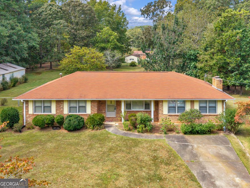 This one is an oldie but a goodie. Very well taken care of home in an established area. The yard has beautifully  mature landscaping. Fenced in back yard. Two driveways. One leading to a detached workshop with overhead door and entry way. This home offers a Living room , Dining room, kitchen with wall oven, cooktop, microwave. Laundry room. There is a sunroom off the dining area. There is three bedrooms and two bathrooms and one has been updated. Very large family room with a fireplace. This home has so many possibilities. Newer roof. Lot is a little over an acre.  Call me for a showing today.