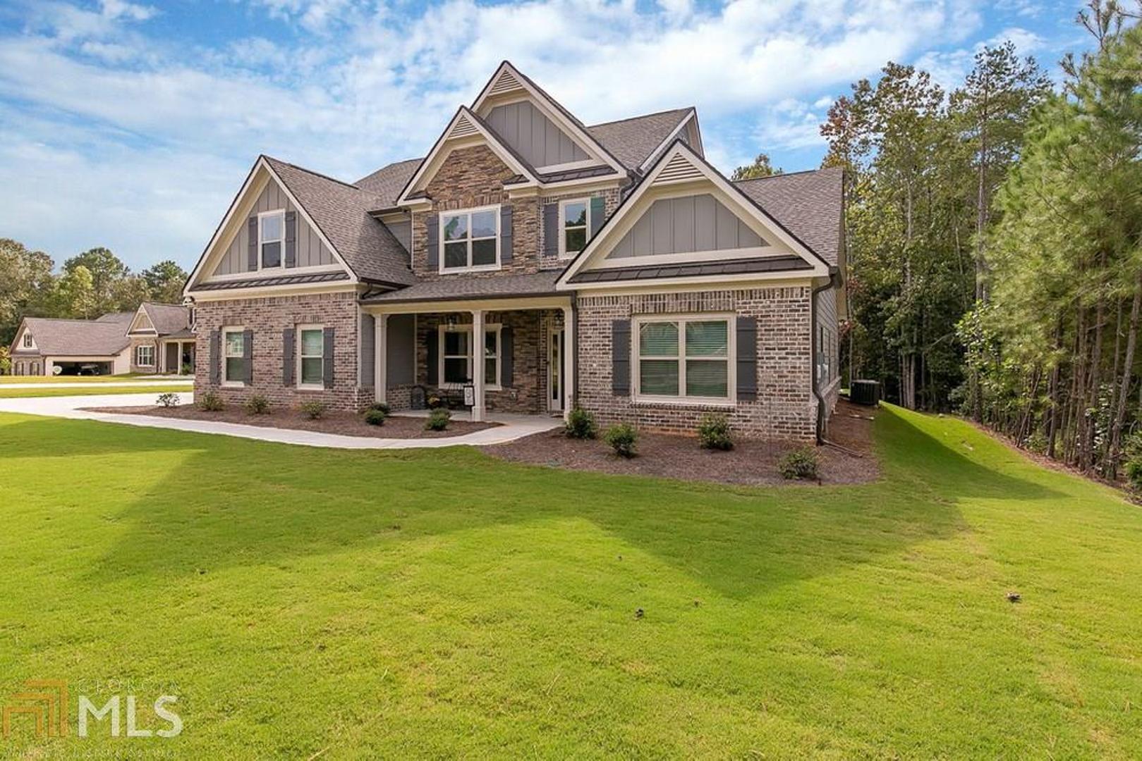 The spacious 2-story home that features owner suite on the main level with trey ceilings, his/her walk-in closets, sitting area, and a private bath with tile shower, garden tub, marble countertops, and tile flooring. The gourmet kitchen has an oversized bar, island, and overlooks the family room with floor to ceiling stone fireplace. The dining room offers a coffered ceiling. Main level guest bedroom and full bath. The foyer, dining, and kitchen/breakfast areas have hardwood floors. Upstairs are 3 additional bedrooms with 2 full baths, as well as a loft. This home has a covered back patio overlooking a large level back yard. Home is like-new and has only been lived in for about a month and the family is being transferred.