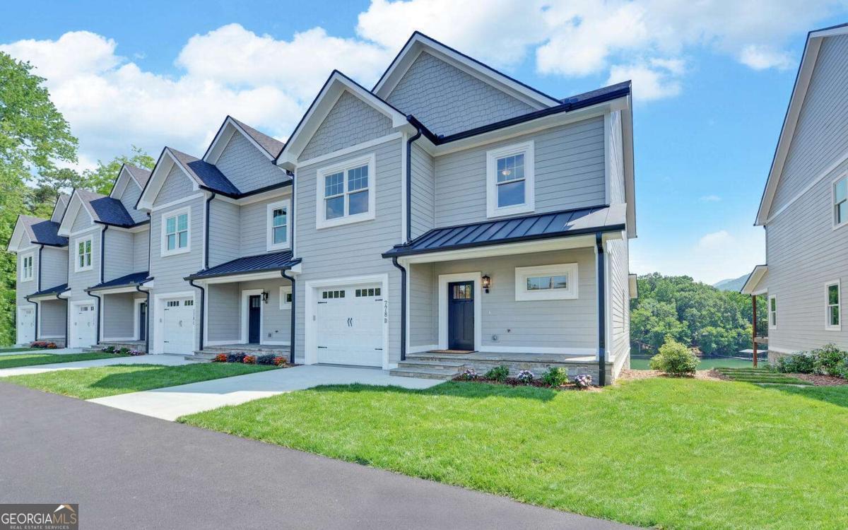 Nearly 3800 sq ft of luxury on three levels, with a private elevator in each home. Lakefront with a covered dock and deeded boat slip, plus a fenced yard. Four bedrooms and four and one half bathrooms, two laundry rooms, a gas log fireplace, a garage and ample additional parking, a mud room/extra pantry space, a gentle cart path down to the dock, and the list goes on. These townhomes have everything you love about lakefront living, without the burden of property maintenance. Take a video tour (see links to video and virtual walk-through), and then come see this home for yourself. Model is open from 11am until 3pm on Saturdays, but can be shown any day and anytime. Don't forget to ask about seller incentives! These townhomes are located in the heart of Hiawassee, offering easy access to shopping, casual dining, and fine restaurants. Hiawassee is a charming town on the banks of the pristine, 7,200-acre Lake Chatuge. The region is known for its hiking, boating, bass and trout fishing, pristine golf courses, resorts/spas, and the Georgia Mountain Fairgrounds and Music venue. We have excellent medical, dental, and vision care services, making it a perfect choice for both full-time living and weekend/seasonal relaxation. $50k premium for end units.