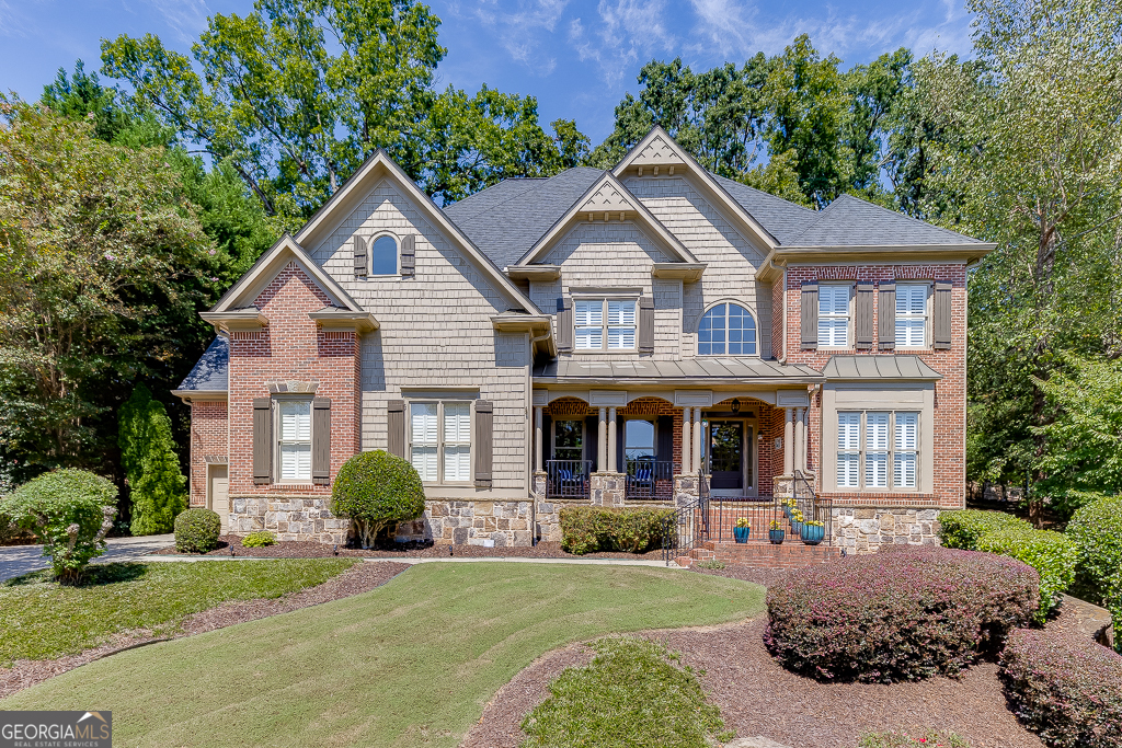 Beautifully maintained and thoughtfully updated, this estate home offers the perfect blend of elegance and comfort. Nestled on a private, wooded cul-de-sac lot, the property boasts a 3-car garage, plantation shutters and 3 sides brick exterior with timeless curb appeal. Step inside to find extensive custom trim details throughout, a welcoming living room with a stacked stone fireplace, and a massive picture window showcasing views of the backyard. The updated chef's kitchen features solid wood cabinetry, brand NEW granite countertops and tile backsplash, NEW appliances, NEW upgraded sink and faucet, and NEW updated lighting. You'll also find plenty of other wonderful spaces on the main floor including a flex room that can serve as home office, playroom etc, formal dining room and a bedroom with full bath that boasts NEW granite top, sink and faucet. This home's thoughtful design includes a two owner's suite plan, offering flexibility and privacy for multi-generational living or long-term guests. Upstairs, the luxurious primary suite is a retreat with a dramatic ceiling, cozy sitting area with fireplace, and a private deck. The spa-like ensuite bath includes two oversized walk-in closets, a soaking tub, separate shower, and dual vanities with NEW updated granite counters, sinks, and faucets. The three additional bedrooms upstairs all feature private bathroom access, and large walk in closet spaces. The fully finished basement serves as a secondary owner's suite space, featuring a full bath, and massive walk in closet space. You'll also enjoy the living room area, unfinished storage and a private entrance. The outdoor living area is designed for year-round enjoyment, complete with a screened-in porch, a huge deck perfect for grilling and entertaining, and a fire pit area ready to enjoy. The home also comes equipped with a full irrigation system, a water softener system, and a new 2025 water heater. This home is the perfect combination of privacy, luxury, and functionality; come see for yourself!