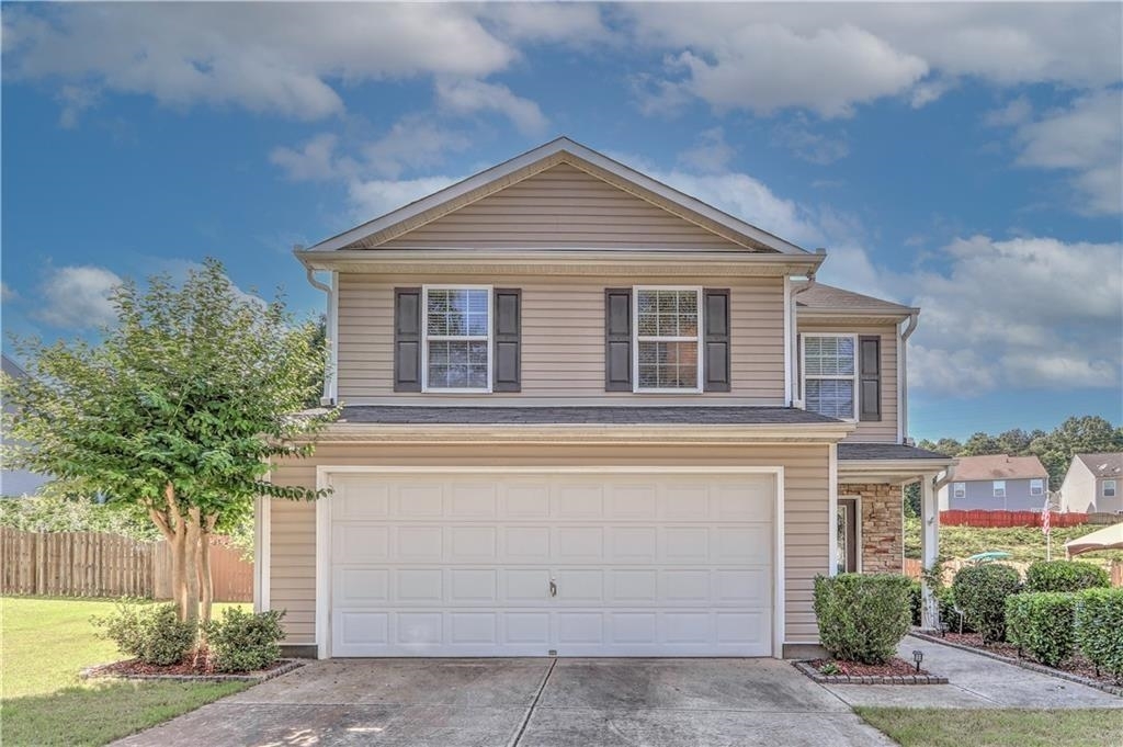 Lovely 2 story home with a landscaped backyard and privacy fence. The dining room/workspace opens to a large family room with a fireplace and two floor-to-ceiling windows. Features open-flow large kitchen with honey-toned maple cabinets, a new dishwasher, garbage disposal, and an eat-in dining area that looks out onto covered patio. The owner's suite has a large walk-in closet, en-suite with tub, shower, and dual sinks. Two Bedrooms or flex space with a full bathroom upstairs. Fenced and landscaped yard, neighborhood features pool, splash pool, lighted tennis courts, basketball, and playground. Convenient location close to GA 400, Restaurants, Lake Lanier, Parks, Shopping, Churches, and Award-winning Schools.