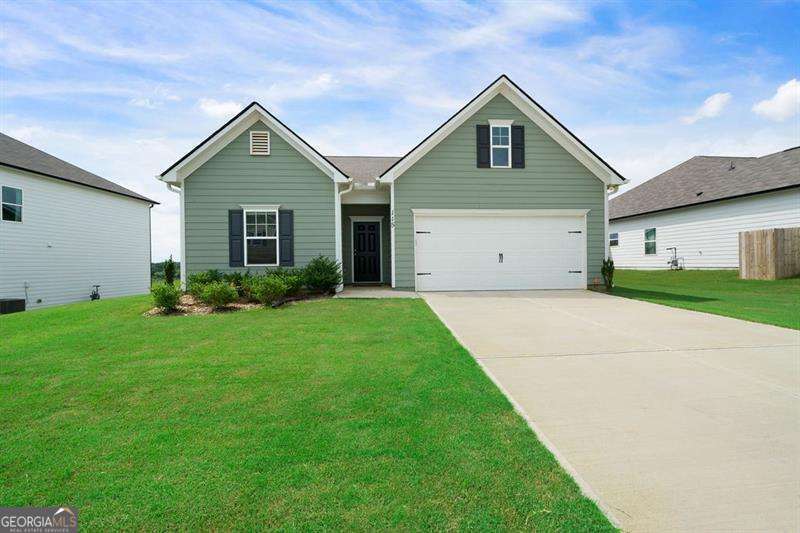 Don't miss this extraordinary opportunity-owners are being transferred, and their nearly new home is now available for someone to make it their own. Built just two years ago and maintained with the utmost care, this better-than-new Bradley floor plan offers the perfect combination of modern elegance, flawless condition, and effortless livability. This 3-bedroom, 2-bath ranch-style beauty is set on a private, level lot in the highly sought-after Stiles community. From the moment you walk in, you'll be struck by the pristine condition and thoughtful upgrades throughout. Rich, durable luxury vinyl flooring runs through the entire home, while every window has custom dual-shade blinds that blend style with soft, filtered light. The bright, open-concept design creates an easy flow between the spacious great room, dining area, and chef-worthy kitchen, which features white cabinetry, a striking oversized island, stylish tile backsplash, gas cooktop, and built-in microwave-all in like-new condition. The split-bedroom layout ensures privacy for all, while the luxurious primary suite serves as a serene retreat with its generous bedroom, spa-inspired en-suite bath, oversized tiled shower with frameless glass doors, and upgraded finishes. The laundry room offers extra storage and includes a newer washer (2023). A spacious two-car garage adds everyday convenience with a Wi-Fi-enabled garage door opener and keypad entry. Outside, the fully fenced backyard is a dream for both entertaining and relaxing. The covered patio-wired for a ceiling fan-overlooks a peaceful, tree-lined backdrop, offering a rare sense of privacy and serenity. The professionally installed irrigation system covers both front and backyards and raised garden beds are already planted with vibrant flowers, fruits, and vegetables-ready for you to enjoy from day one. Set in a vibrant, amenity-rich neighborhood, The Stiles offers residents access to a resort-style pool, playground, and beautifully maintained green spaces. All this, just minutes from top-rated schools, major highways, Lake Allatoona, downtown Cartersville, Lake Point Sports Complex, and a wide array of dining, shopping, and outdoor recreation. Homes this new and in this perfect condition rarely come on the market-schedule your private showing today before this turnkey gem is gone!